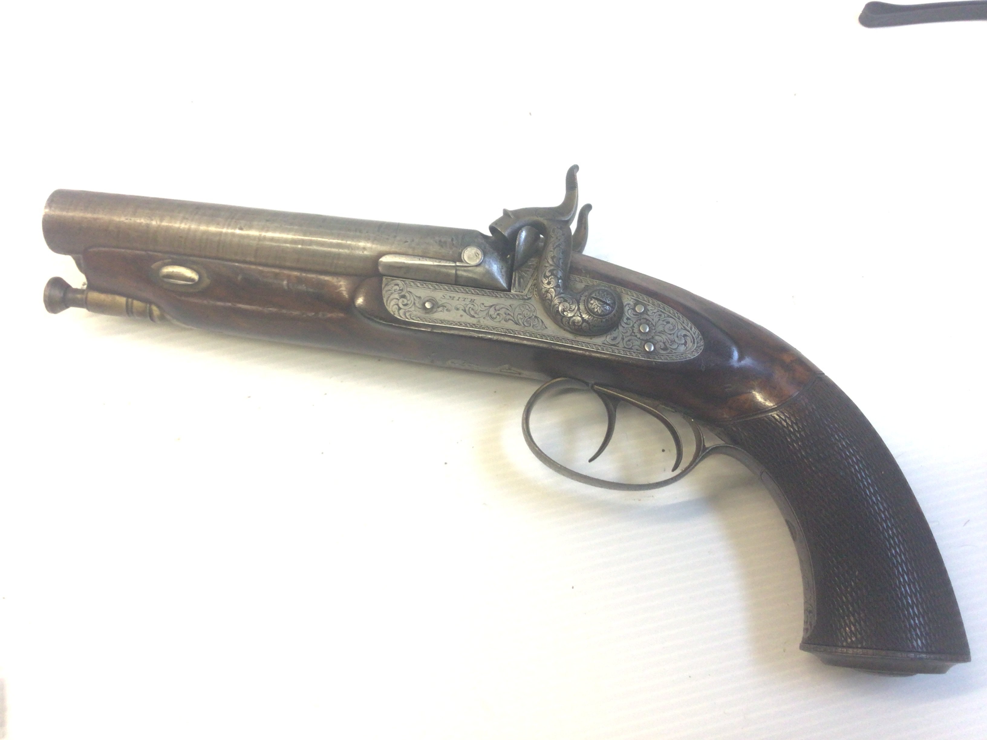 A Nice Example of an early 19th century double barrel muzzle load percussion pistol maker Smith London. The hammers and action with scroll engraving with a walnut stock length 30cm action functional.