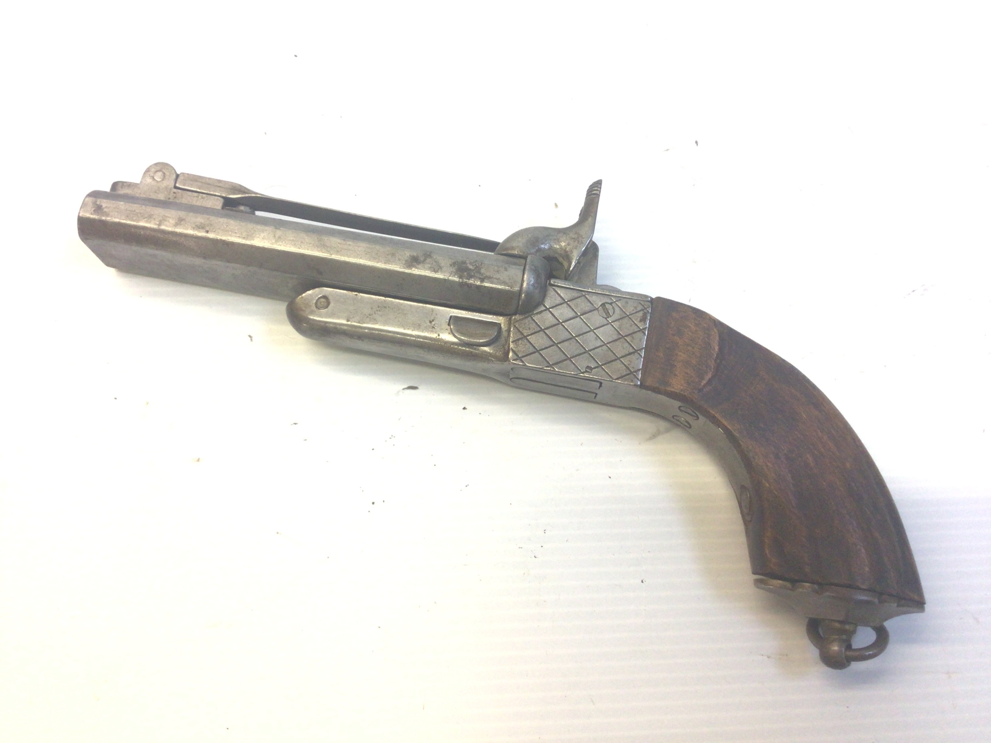 A 19th century rim fire double barrel pistol with top bayonet retractable trigger.