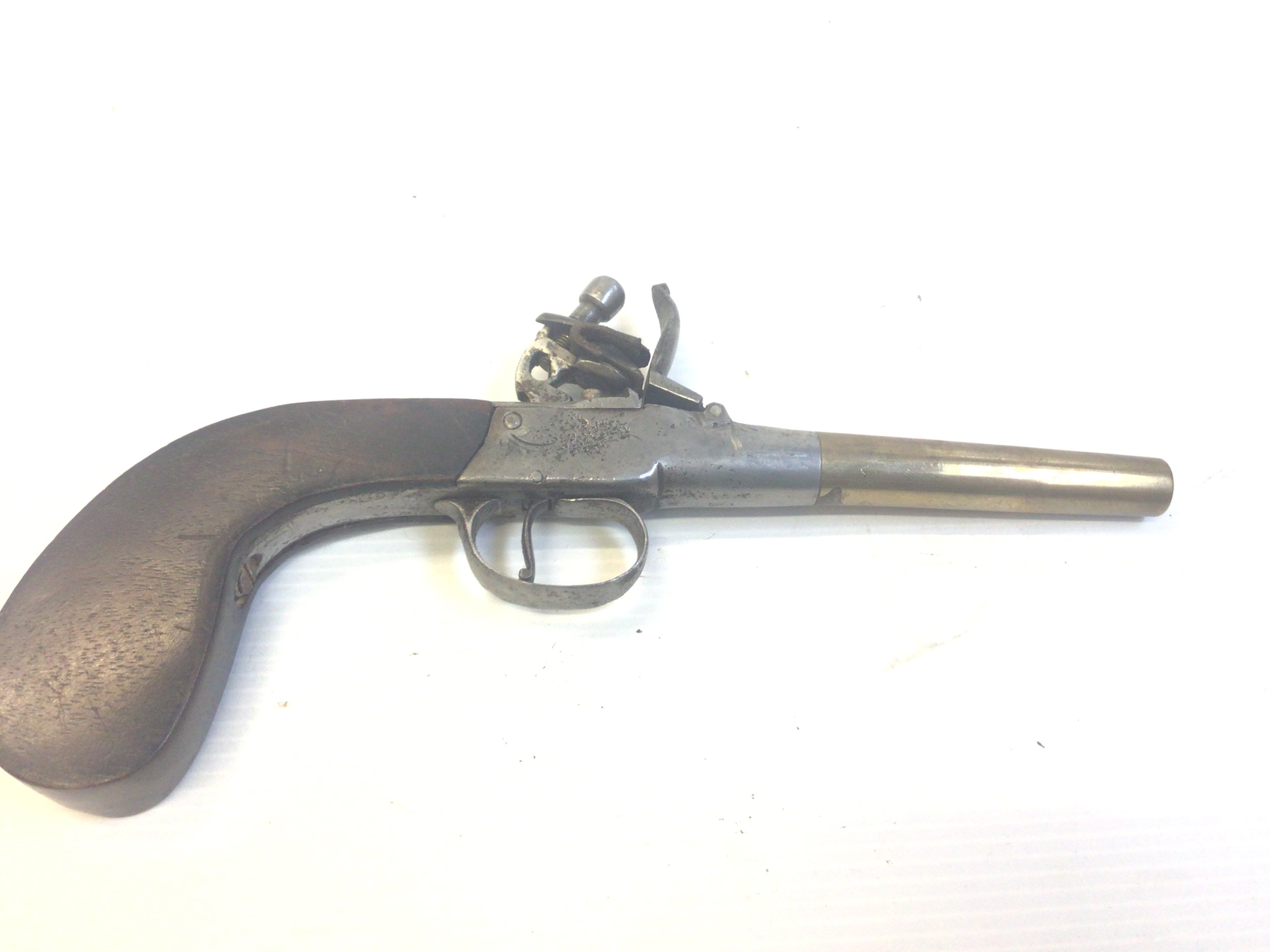 An early 19th century flintlock pistol with a brass tapering barrel.