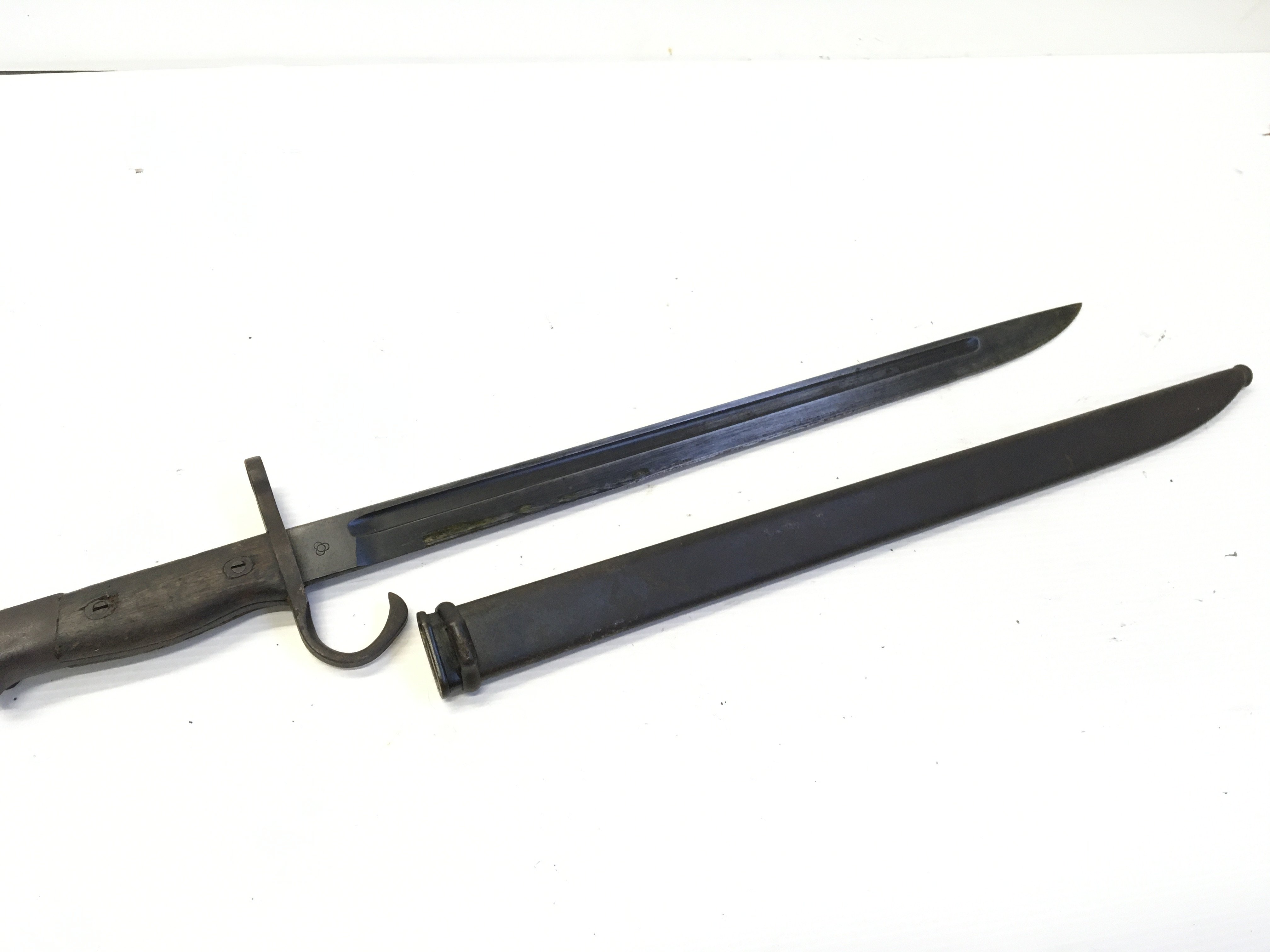 A Japanese II world war Arisaka bayonet with marks to the steel blade.
