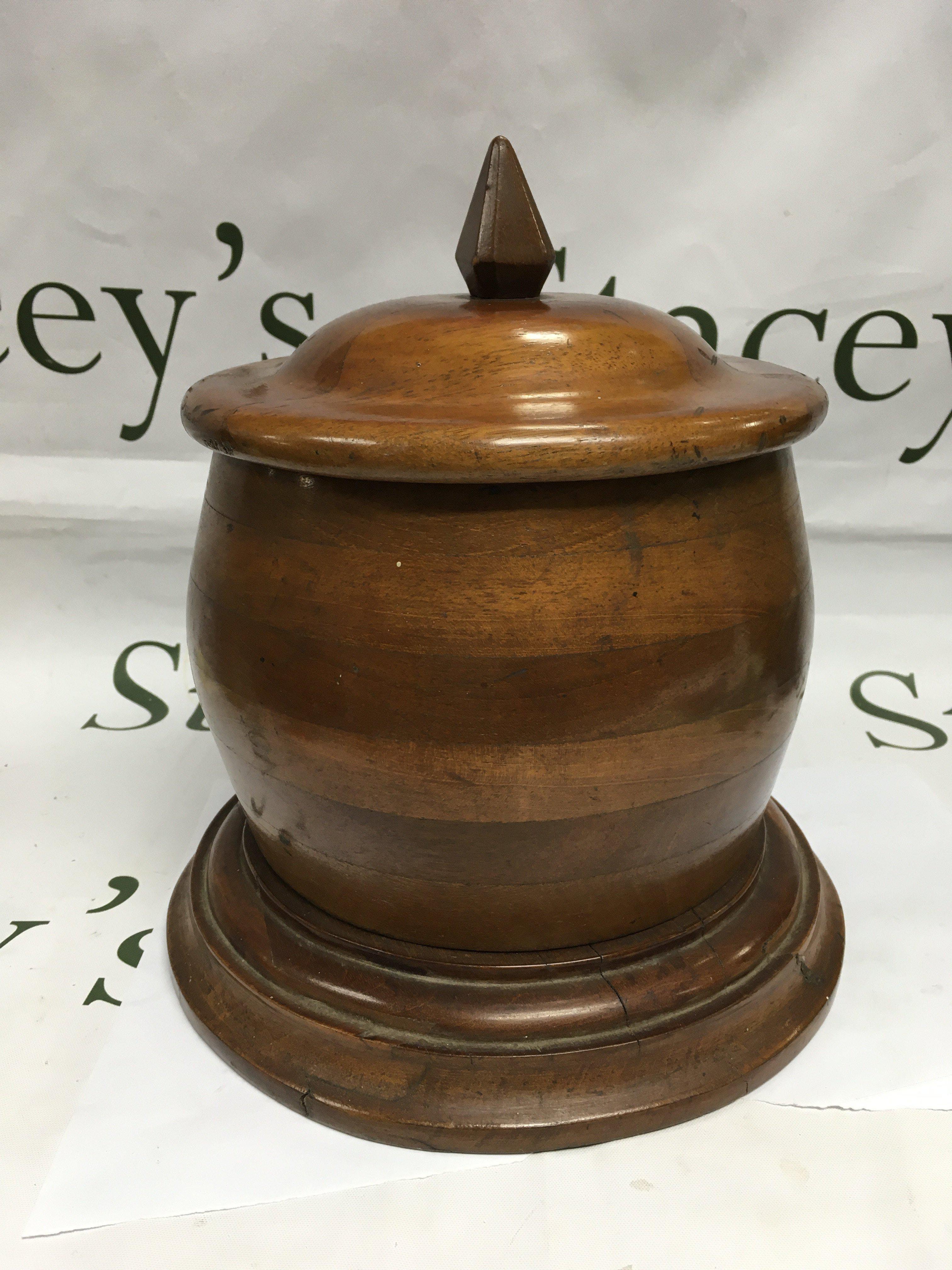A large biscuit or tobacco jar made from a WWI era propeller.