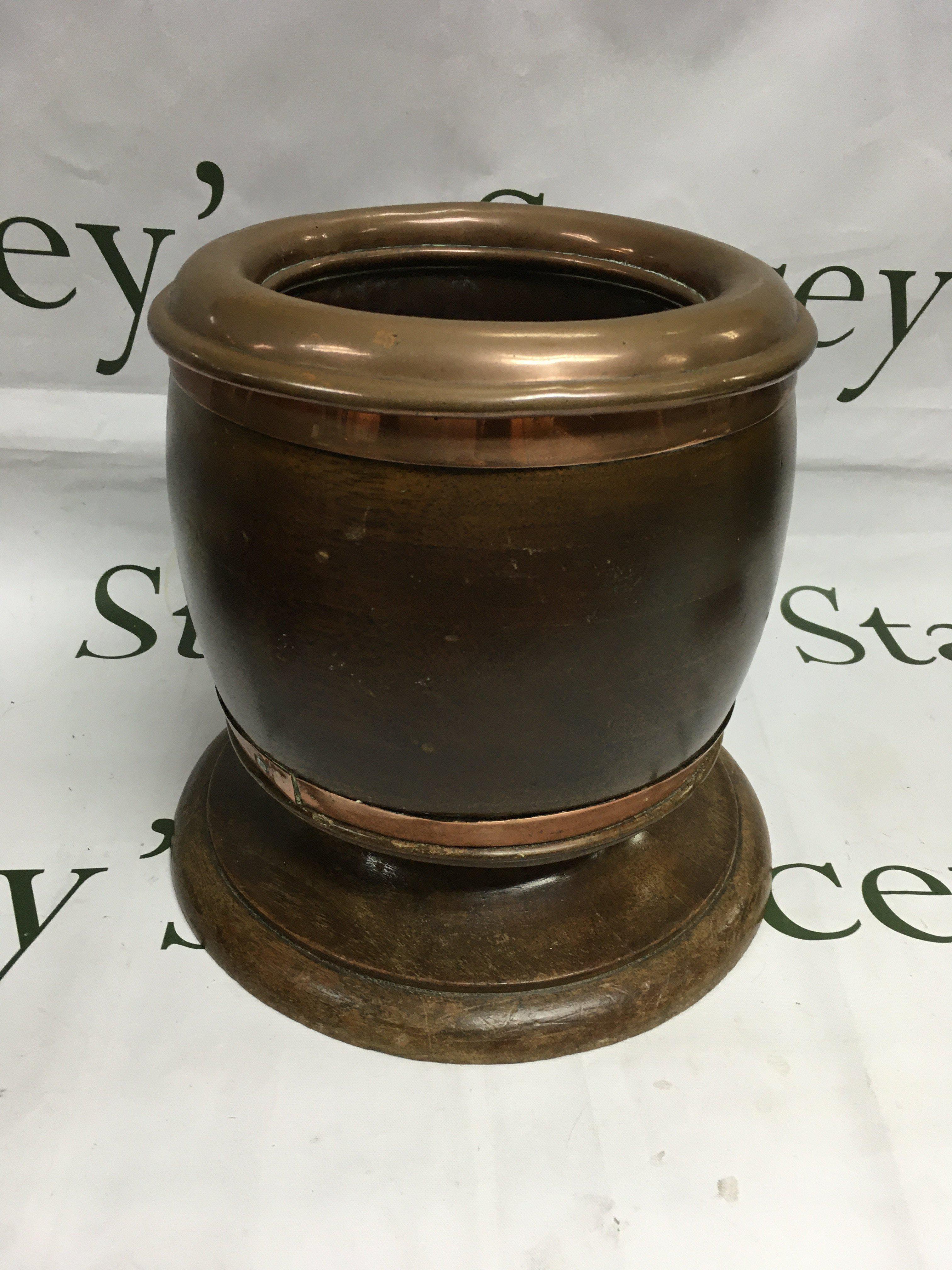A large ice bucket made from WWI era propeller boss with hand made copper insert with additional copper banding.
