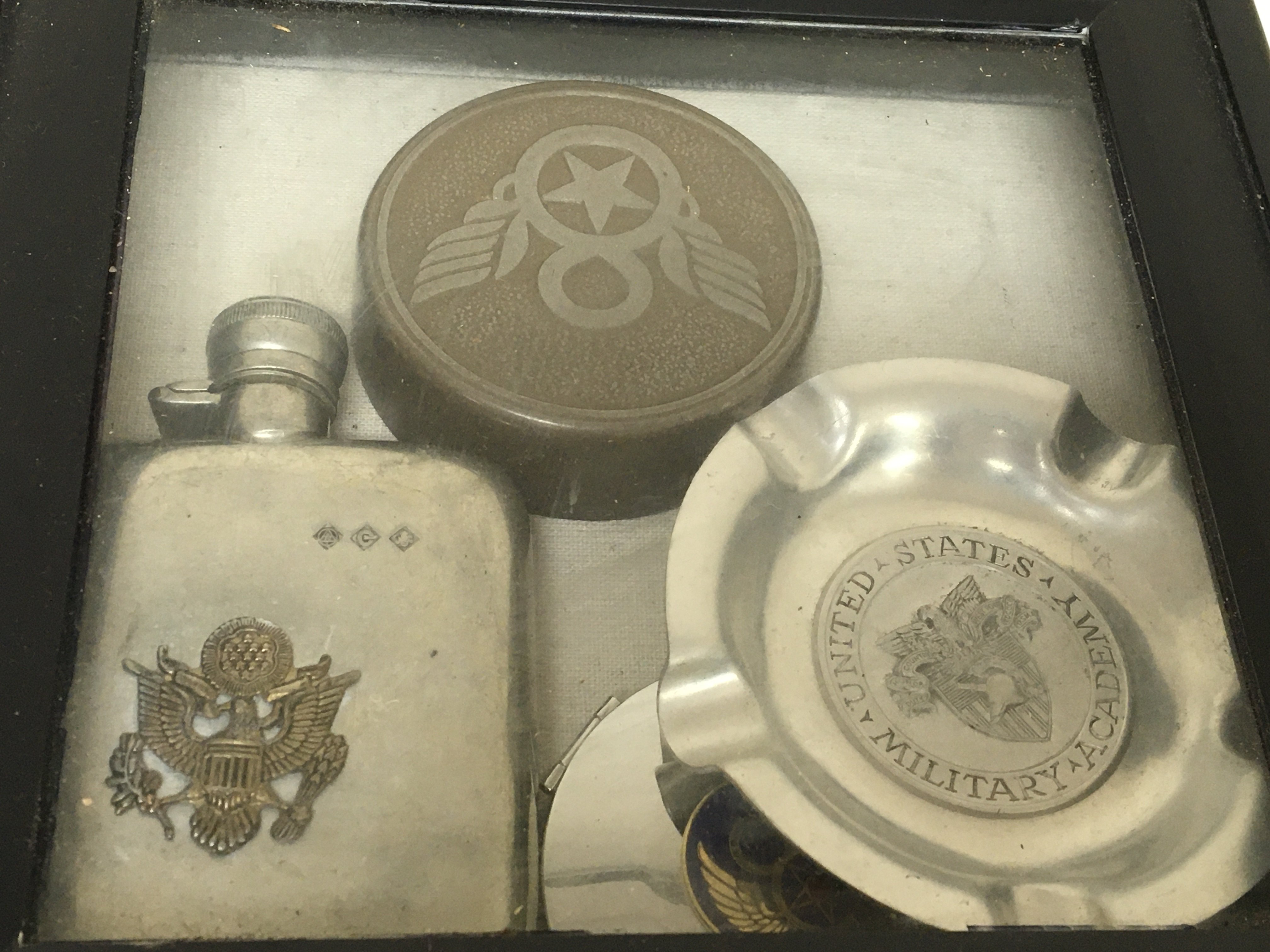 A case containing an American Hip flask desk paperweight ash try lighter Military related.