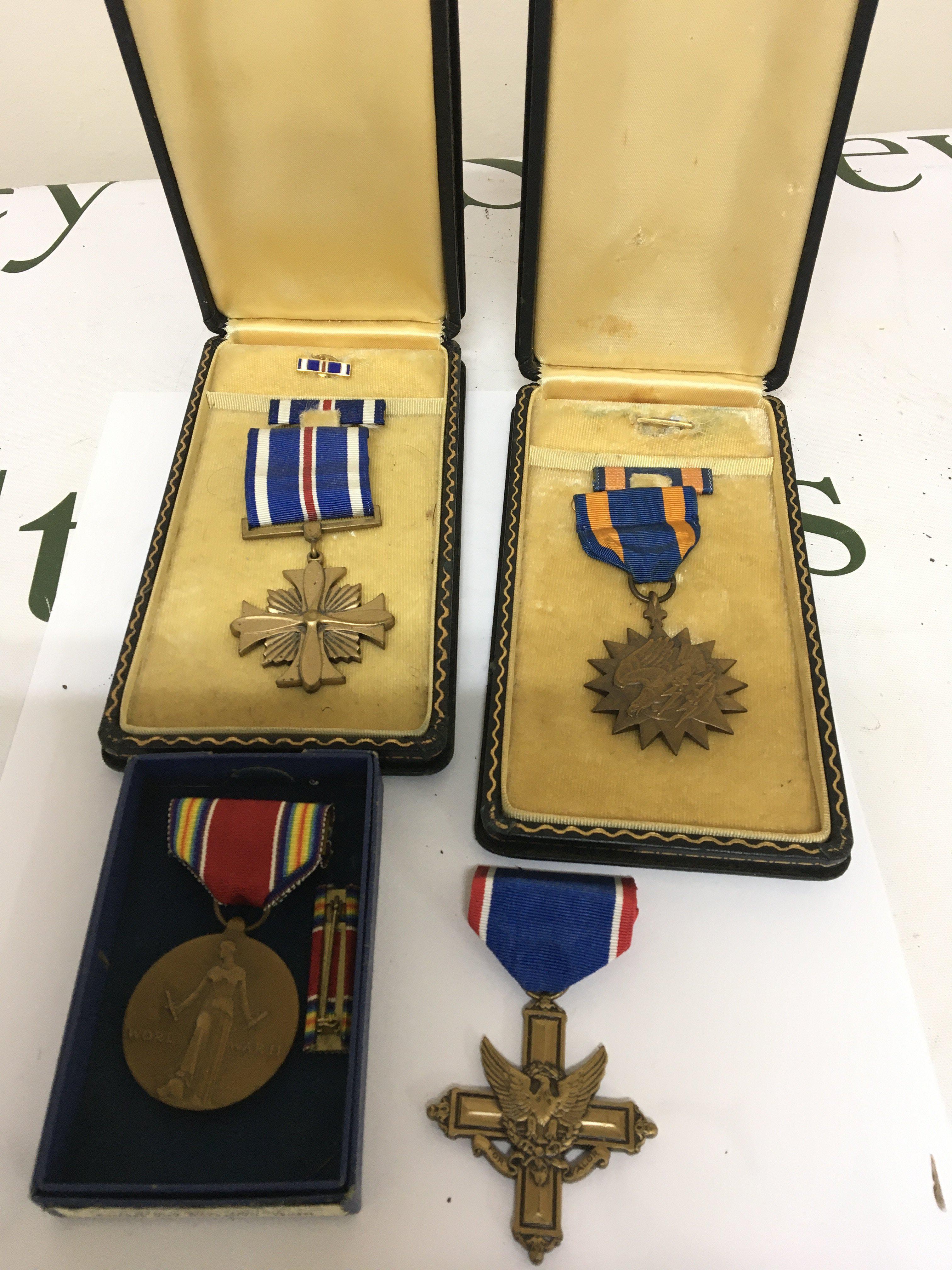 A Group of II world war American medals including Distinguished Flying Cross in a fitted box Air Medal in a fitted box Campaign service medal in original box and one other.