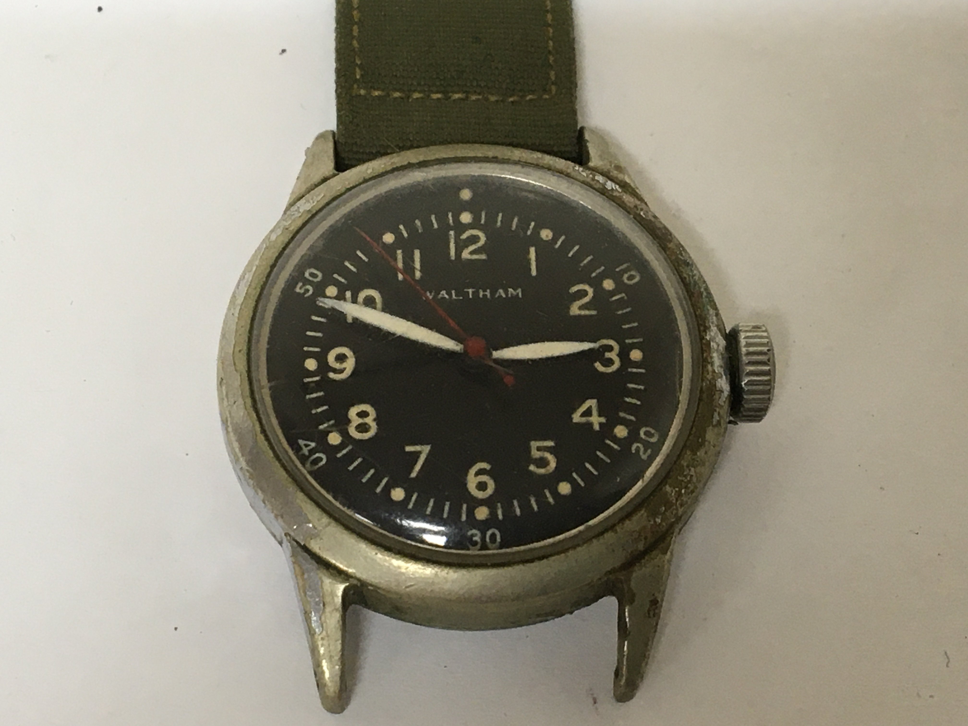 An American Military Waltham Watch black dial red second hand not seen working.