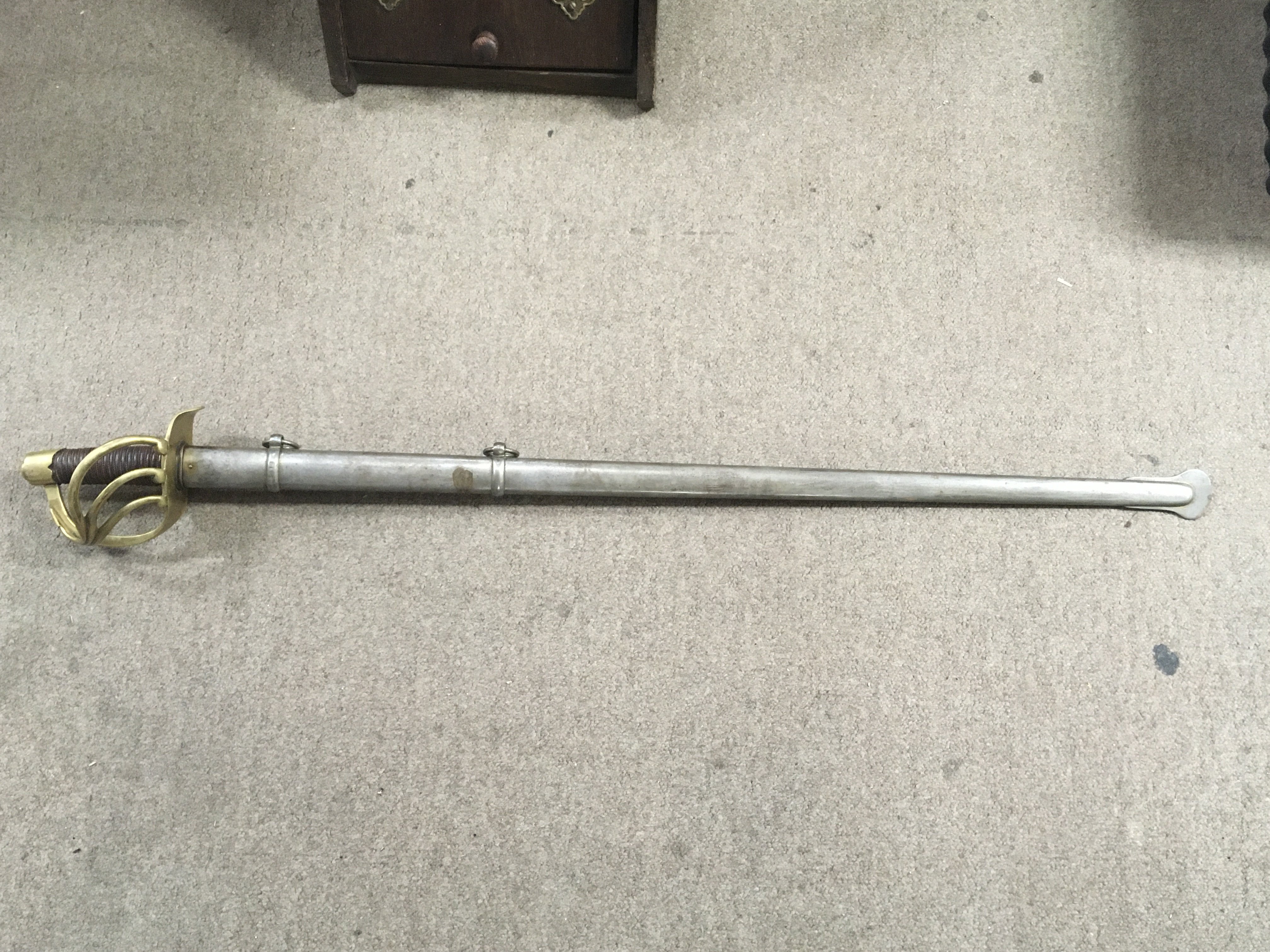 A French 1813 pattern heavy cavalry sword with a gilt hand guard, leather grip , scabbard with matching serial number. blade 96cm long approximately 112cm total length . This lot cannot be posted