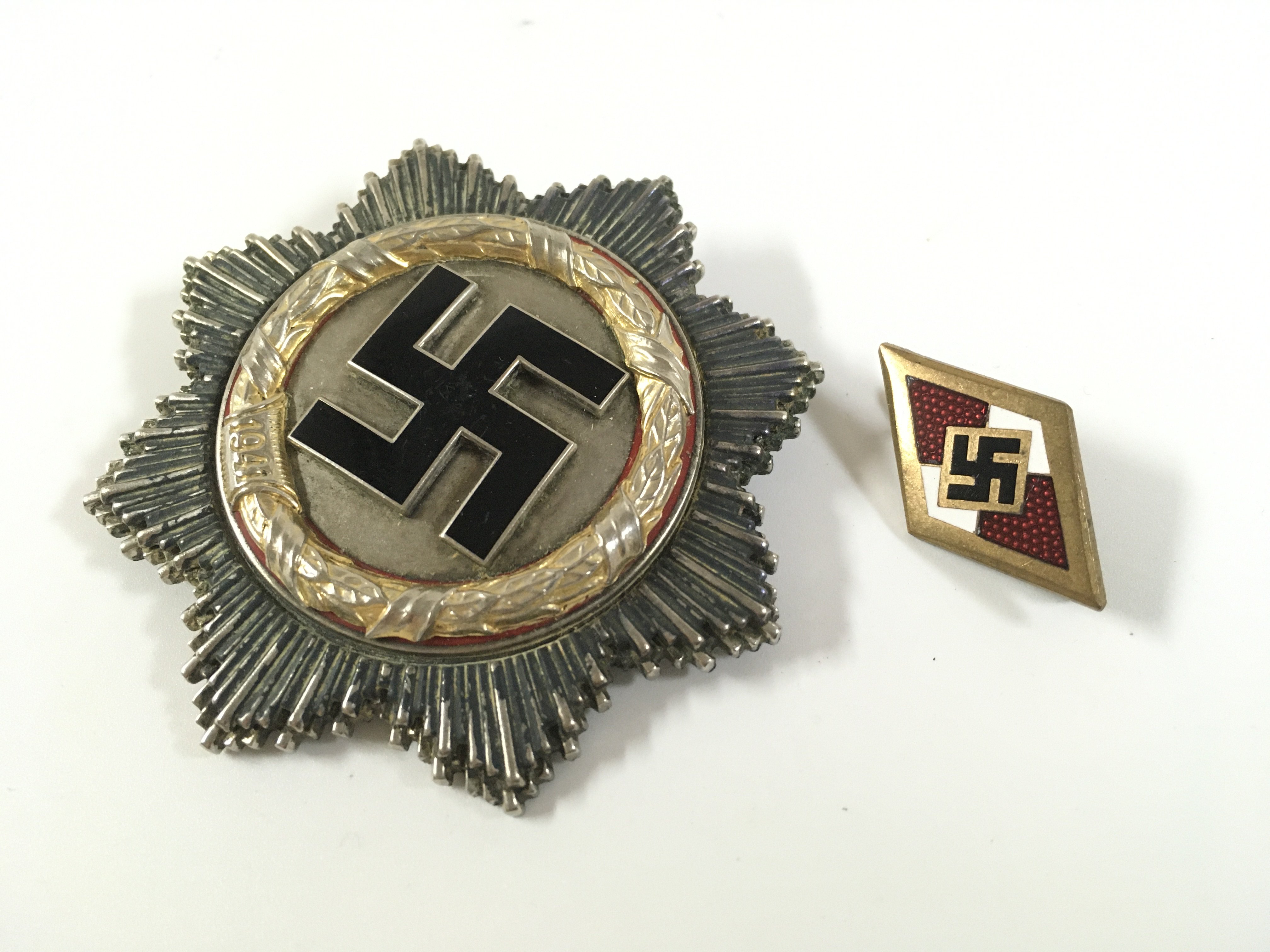 A Third Reich German cross and a Hitler youth honour badge . Postage category A