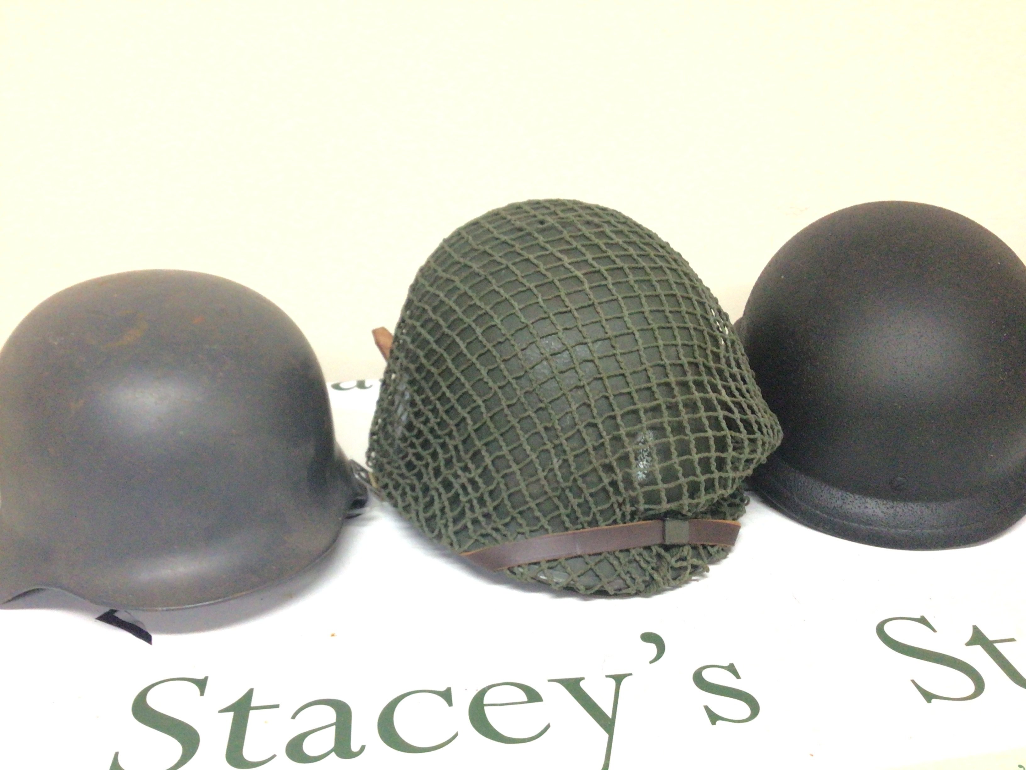 An American Military helmet a UN type helmet and a replica German II world war helmet (3)