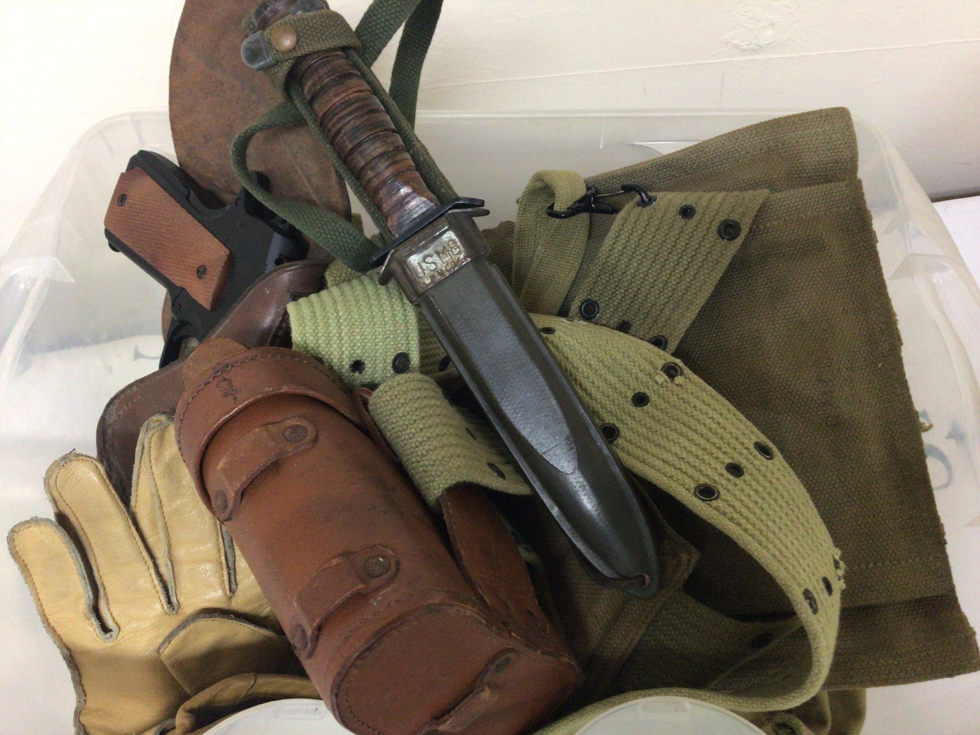 A collection of American II world war and latter webbing including a replica non firing revolver a USM8 combat Knife and associated items