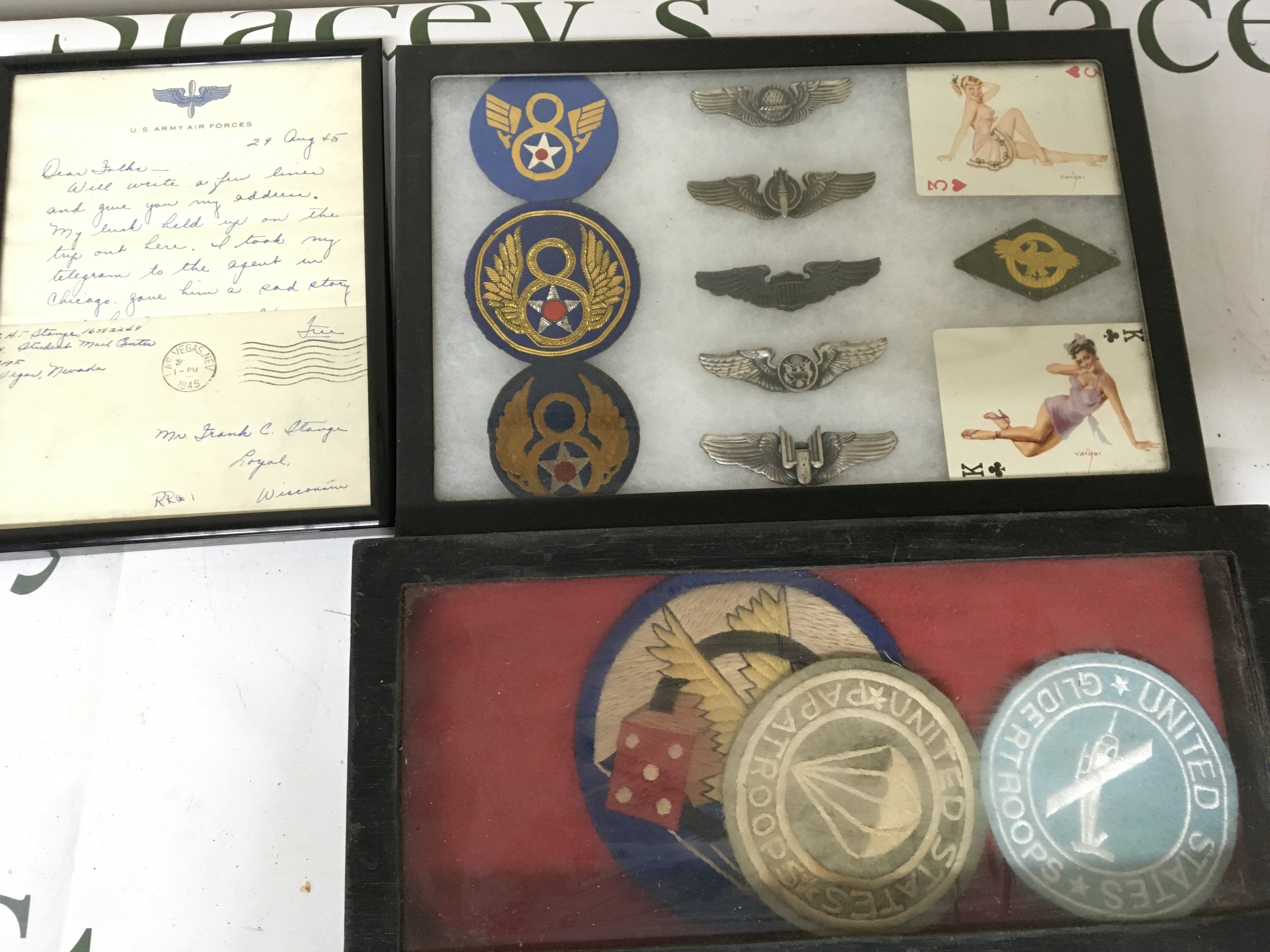 A group of American badges cloth badges and a letter dated 1945 framed. (3)