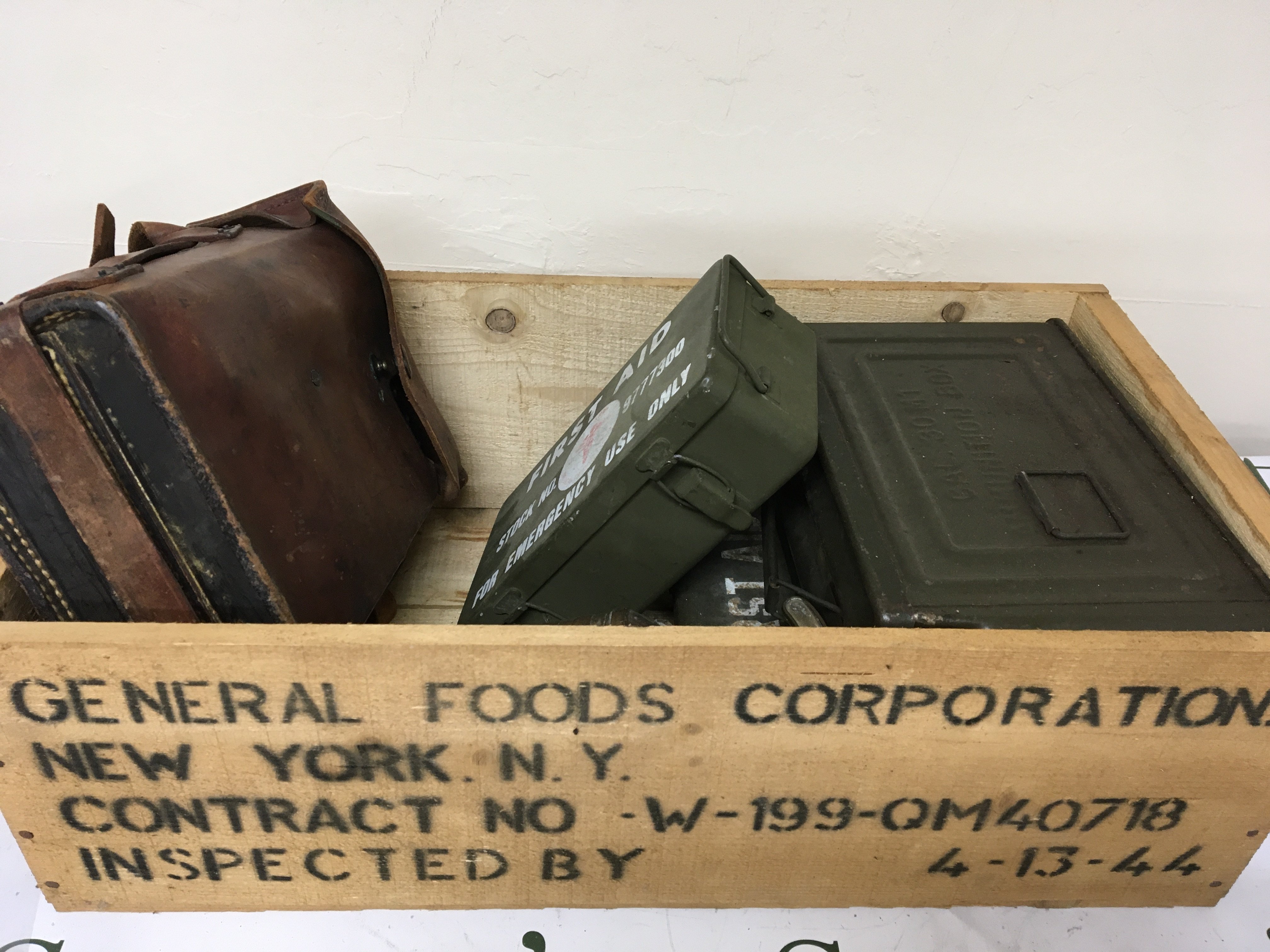 An American II world war food box containing an American field telephone First Aid Kits ammunition tins
