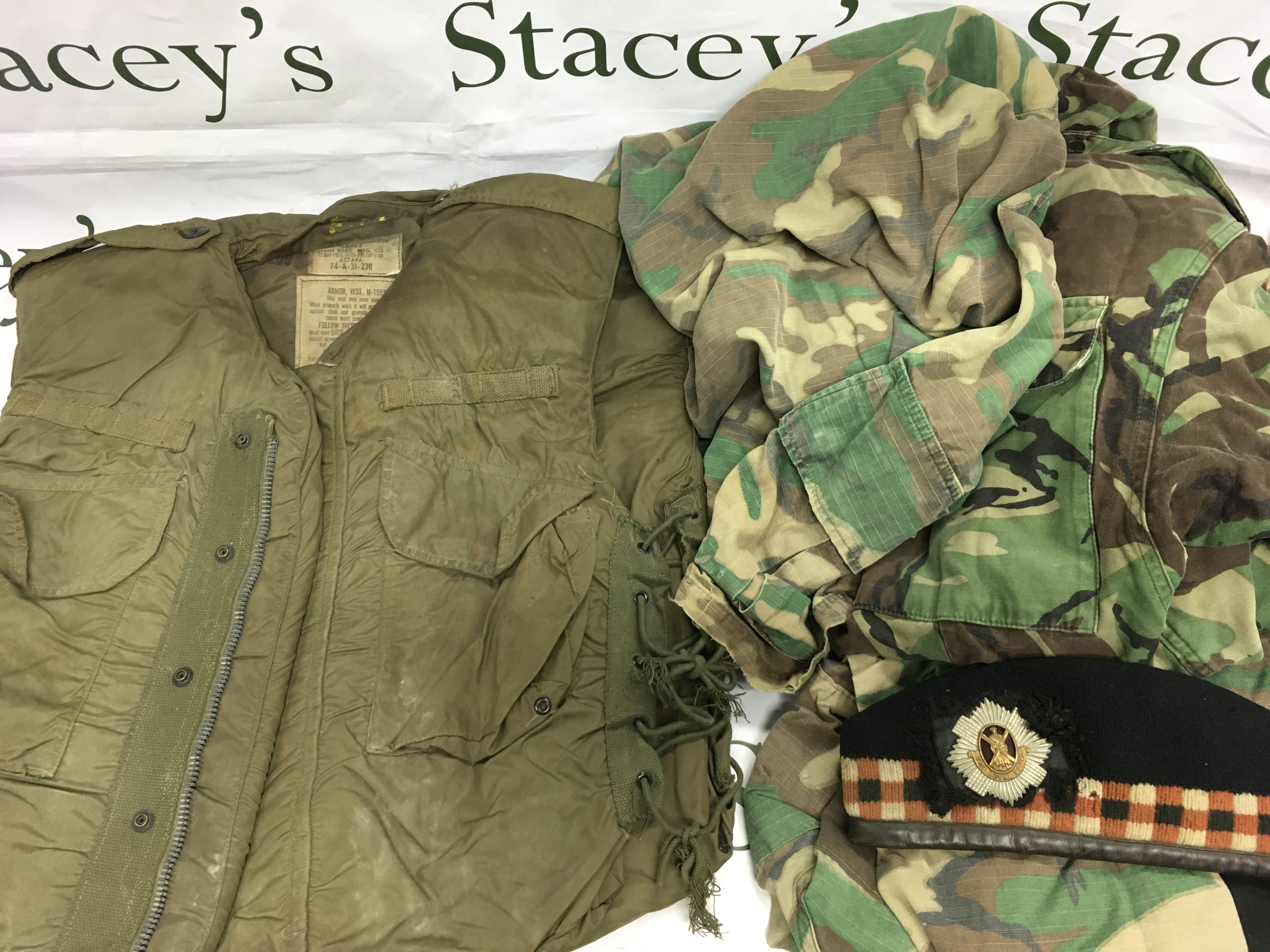 A collection of various military uniforms and fatigues. Shipping category D.