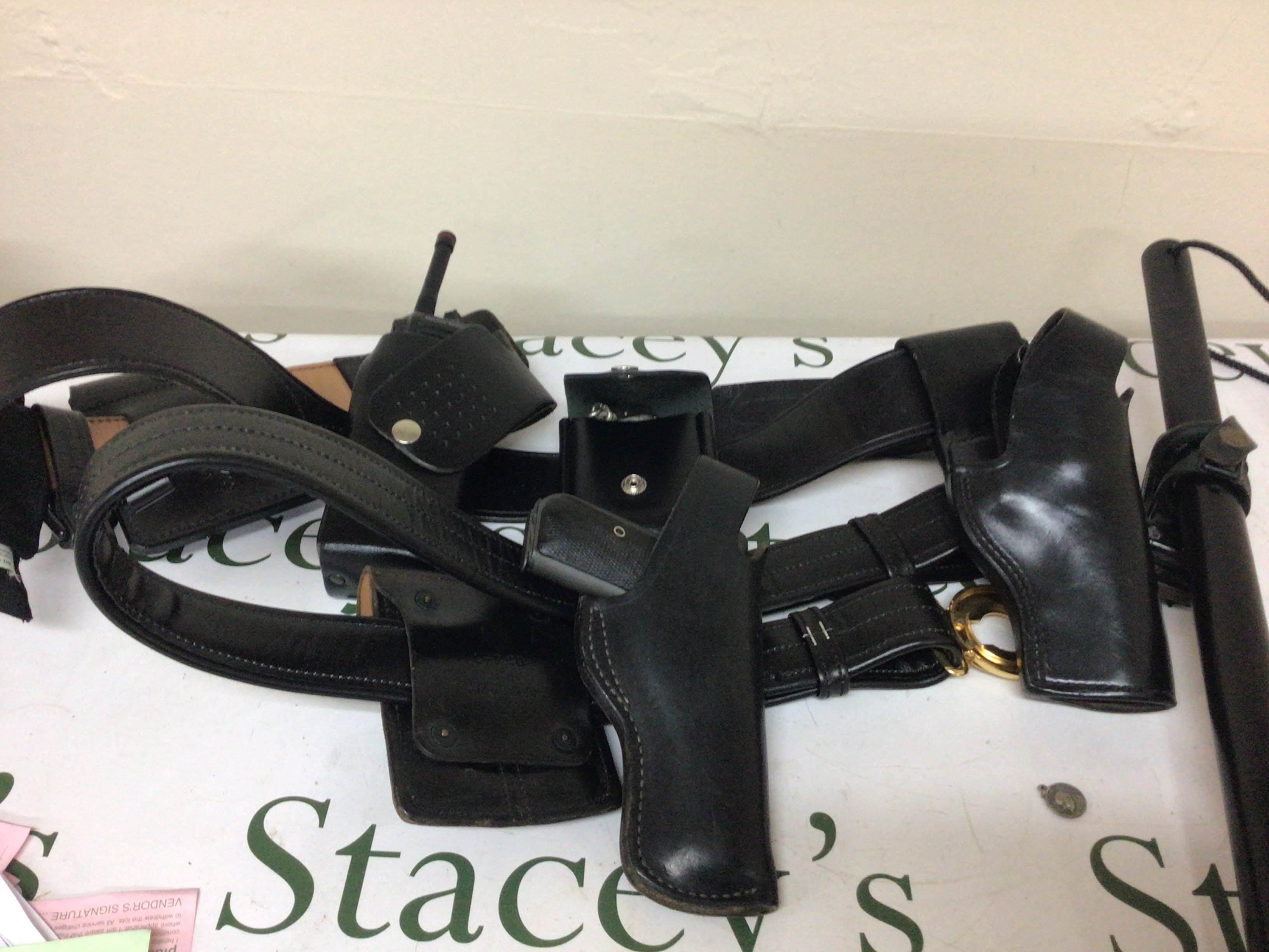 An American Police leather belt with handcuffs radio non firing replica Colt .380 and a baton.