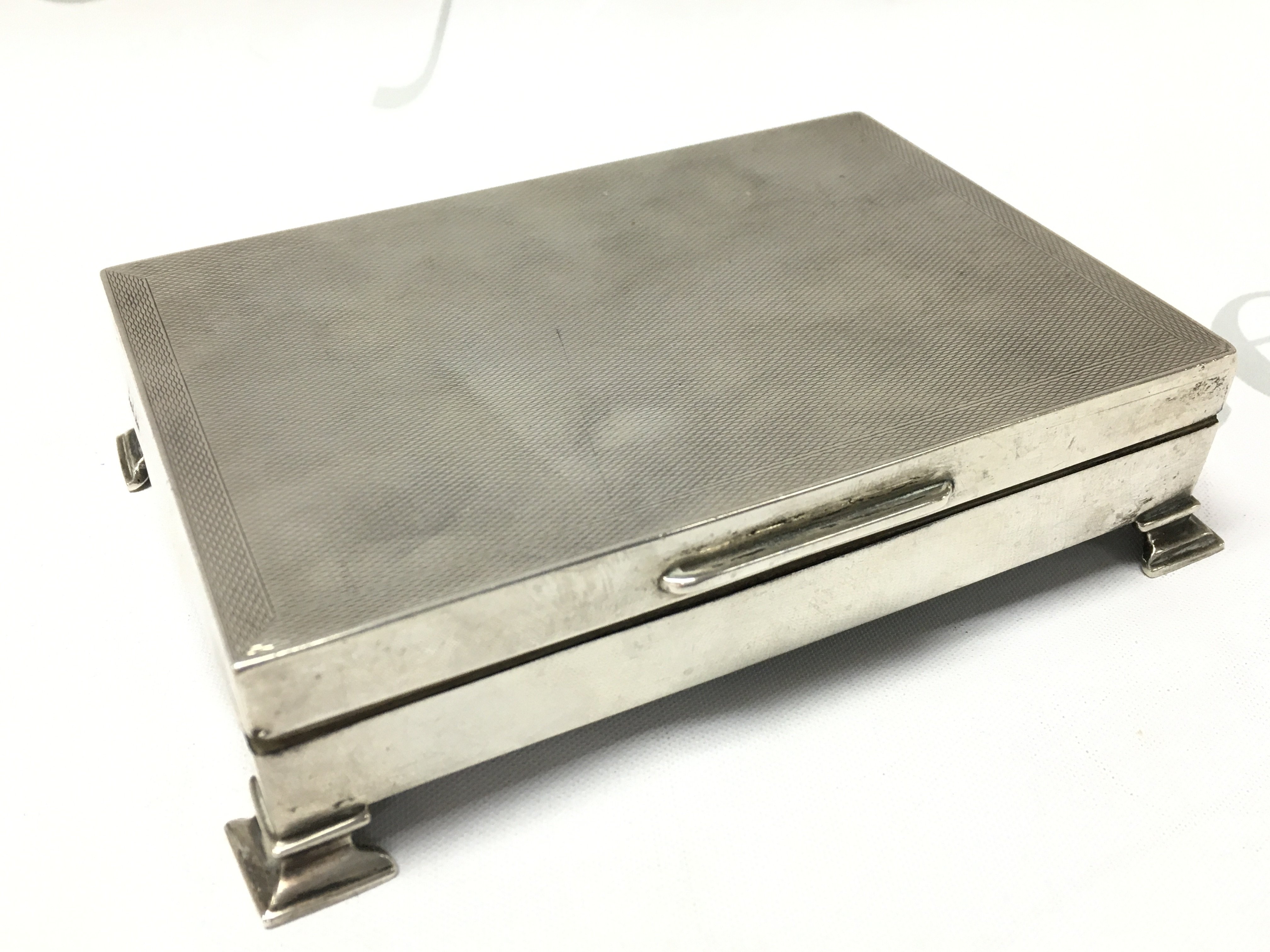 A Silver cigarette case , postage category B