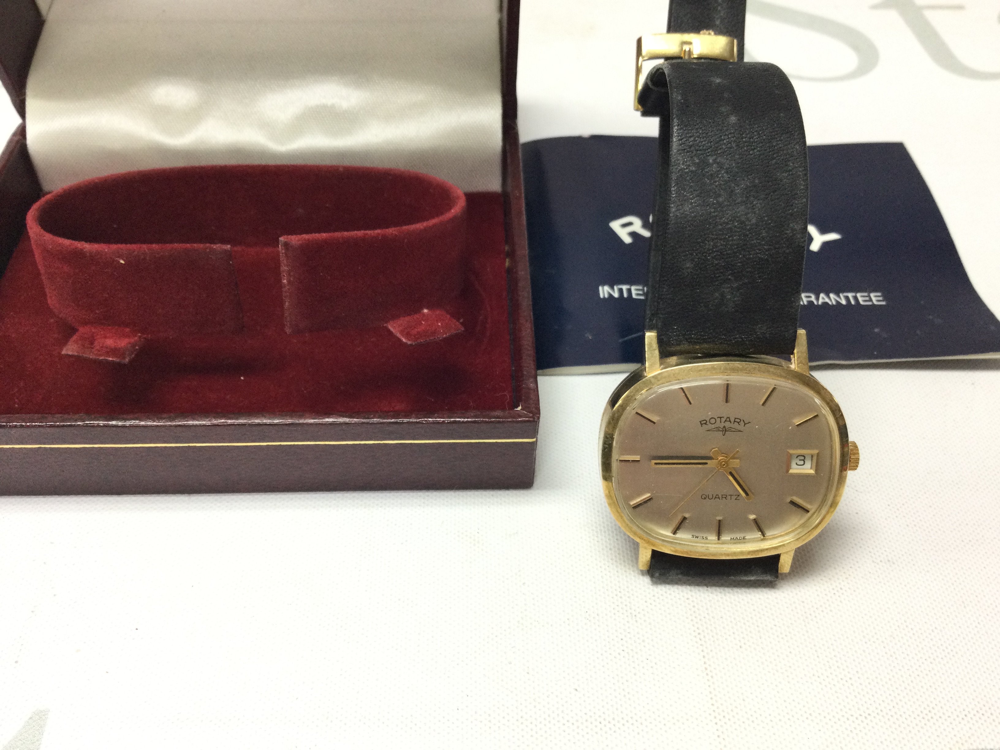 A 1980s 9ct gold gents Rotary wrist watch on black leather strap. Not seen working comes with box and papers. 27g total weight. Postage B