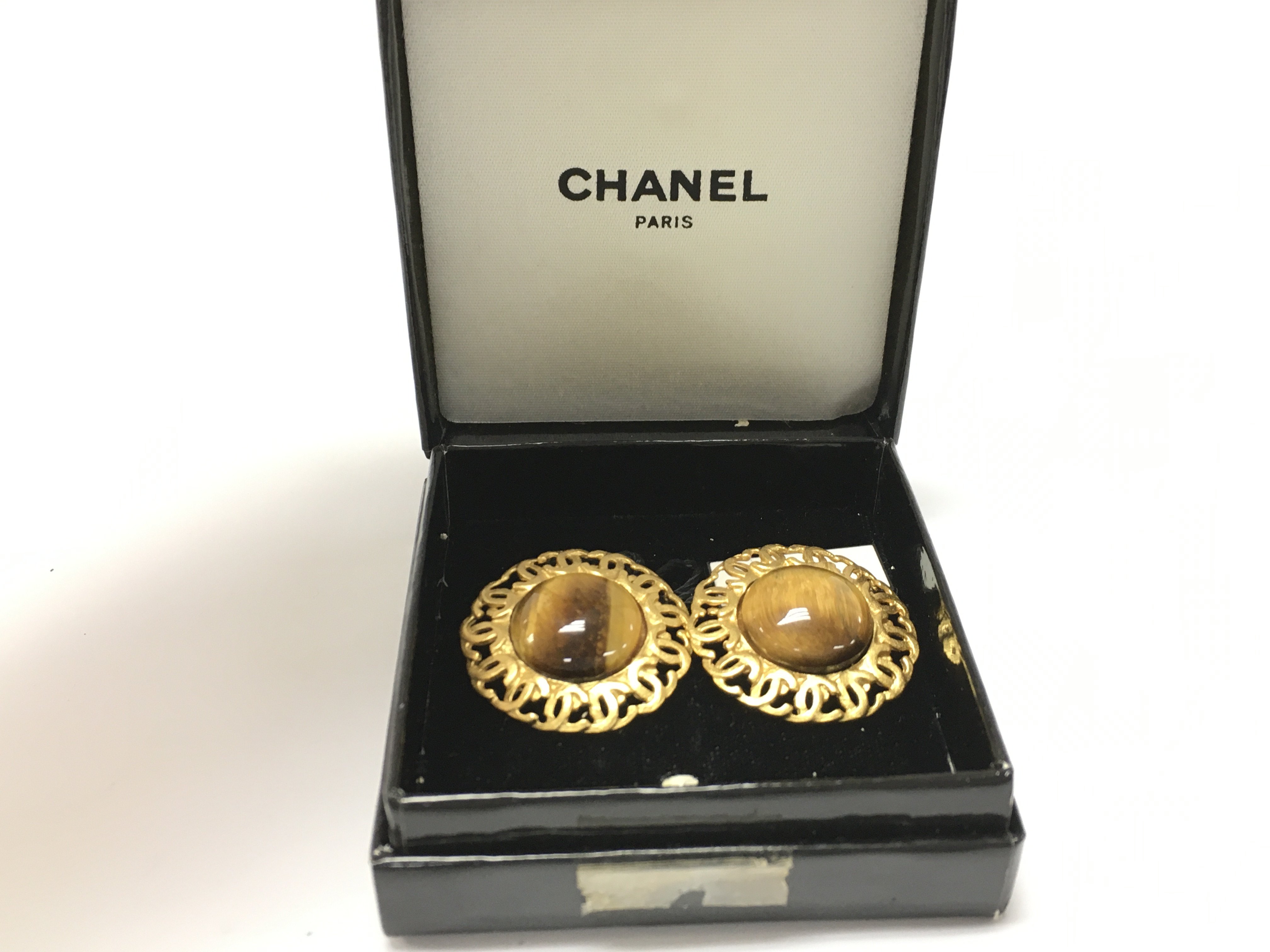 A boxed pair of Chanel tigers eye clip on earrings
