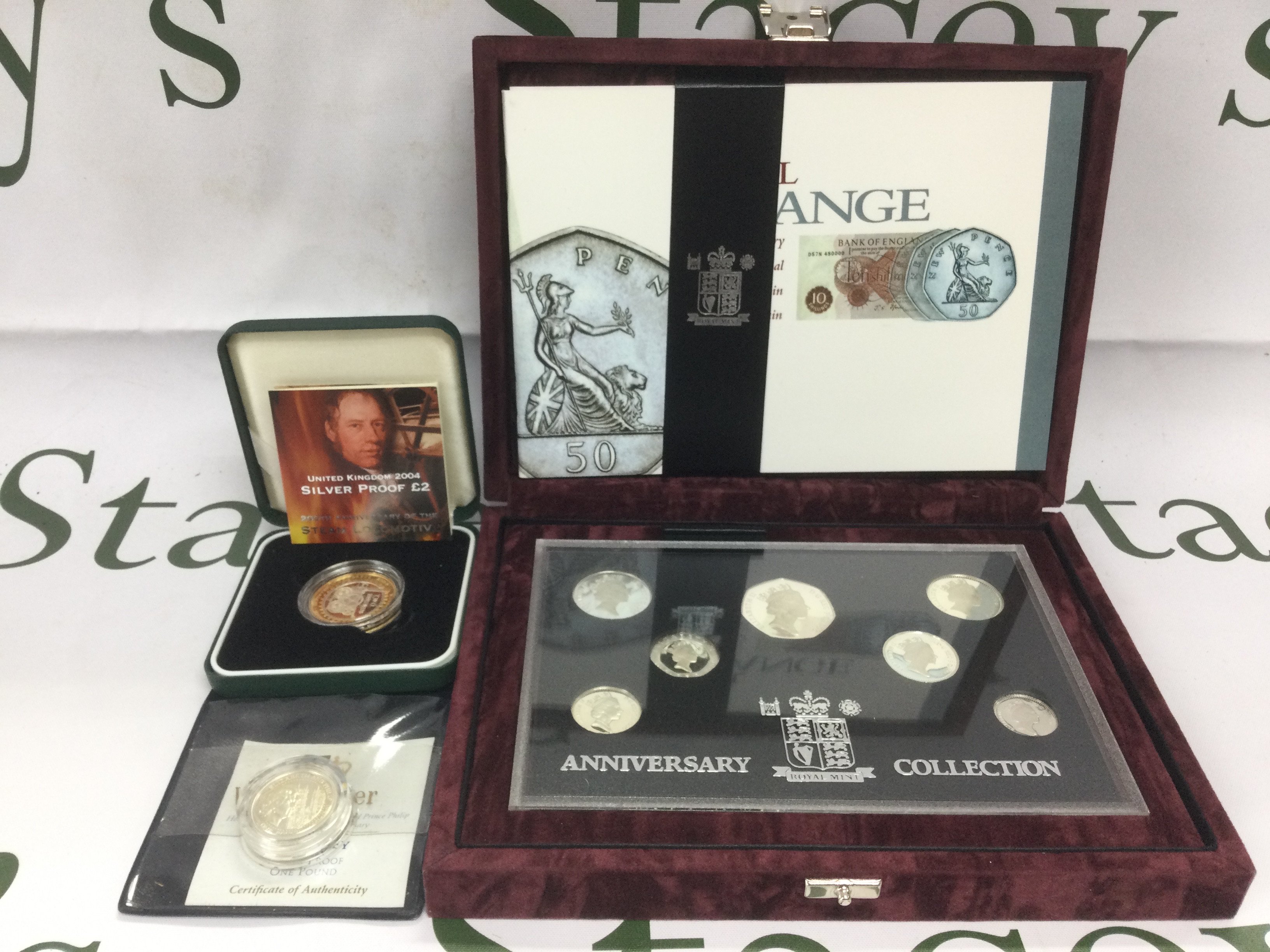 A cased Royal Mint Anniversary Coin Collection and two silver proof coins. Shipping category B.