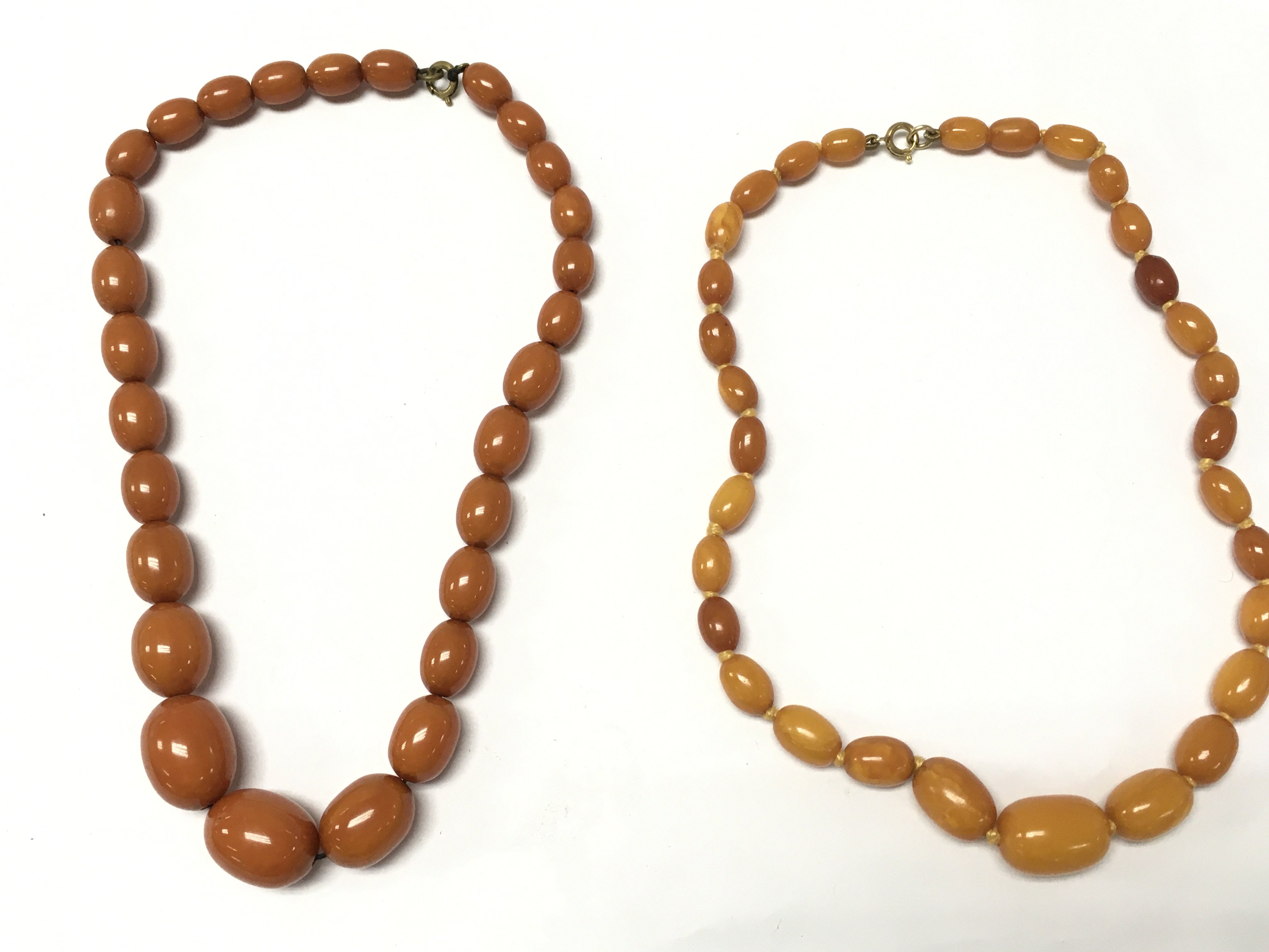 Two amber necklaces . Postage category A
