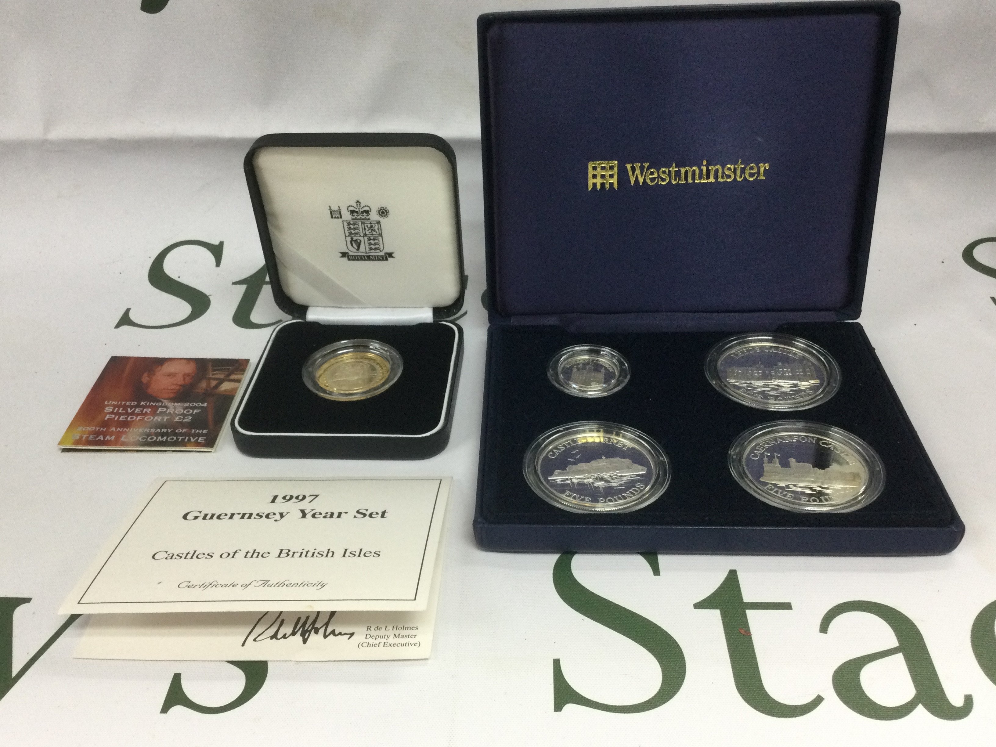Two cased silver proof coin sets comprising a 1997 Guernsey Year set and a Piedfort &pound;2 coin. Shipping category A.