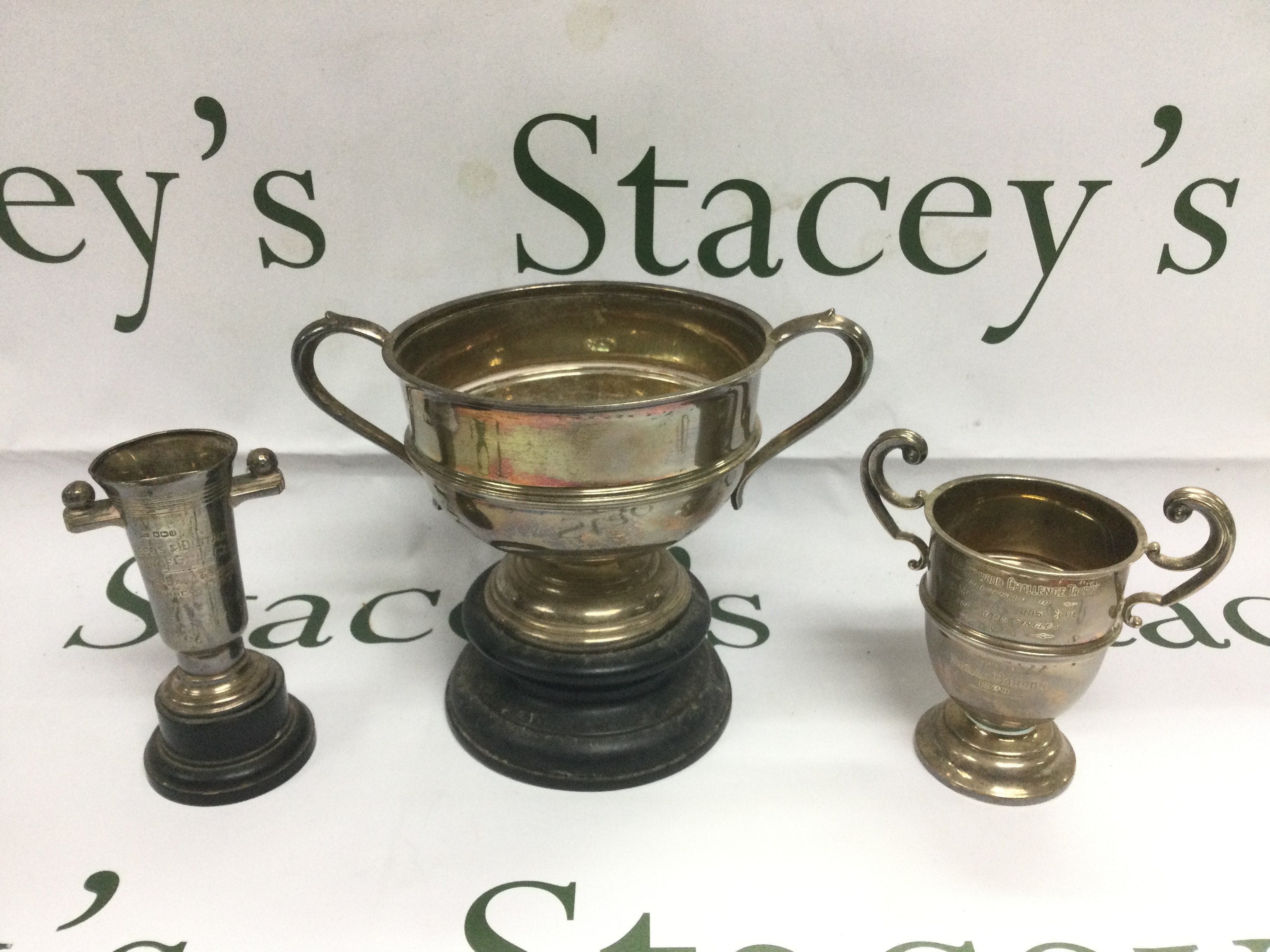 Three silver trophy cups, different assays, tallest approx 15.5cm. Shipping category D.