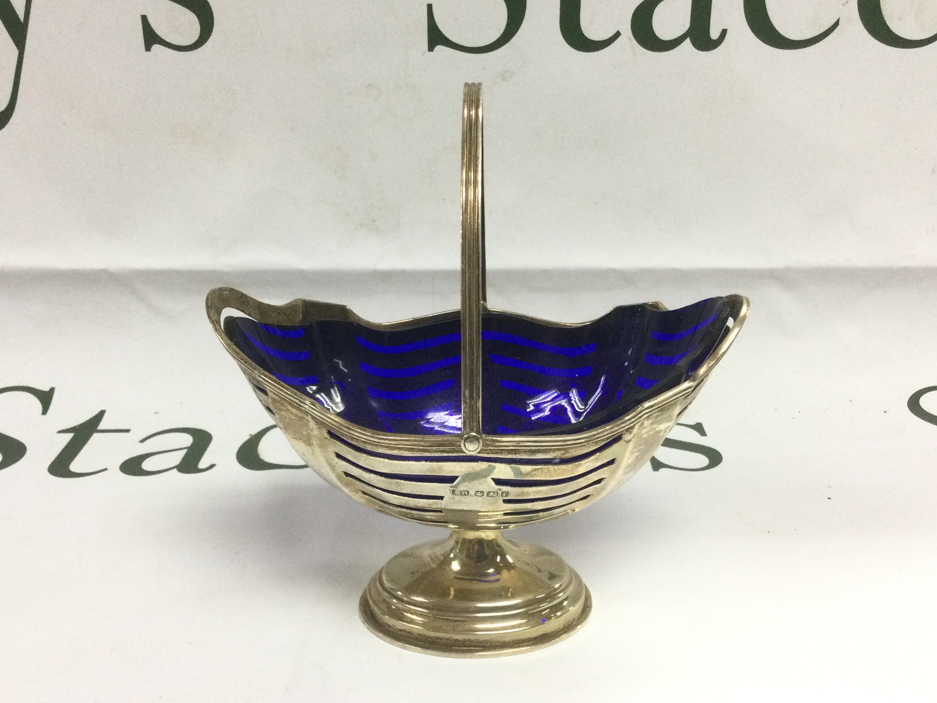 A silver swing handled sugar basket, Sheffield 1898. Shipping category D.