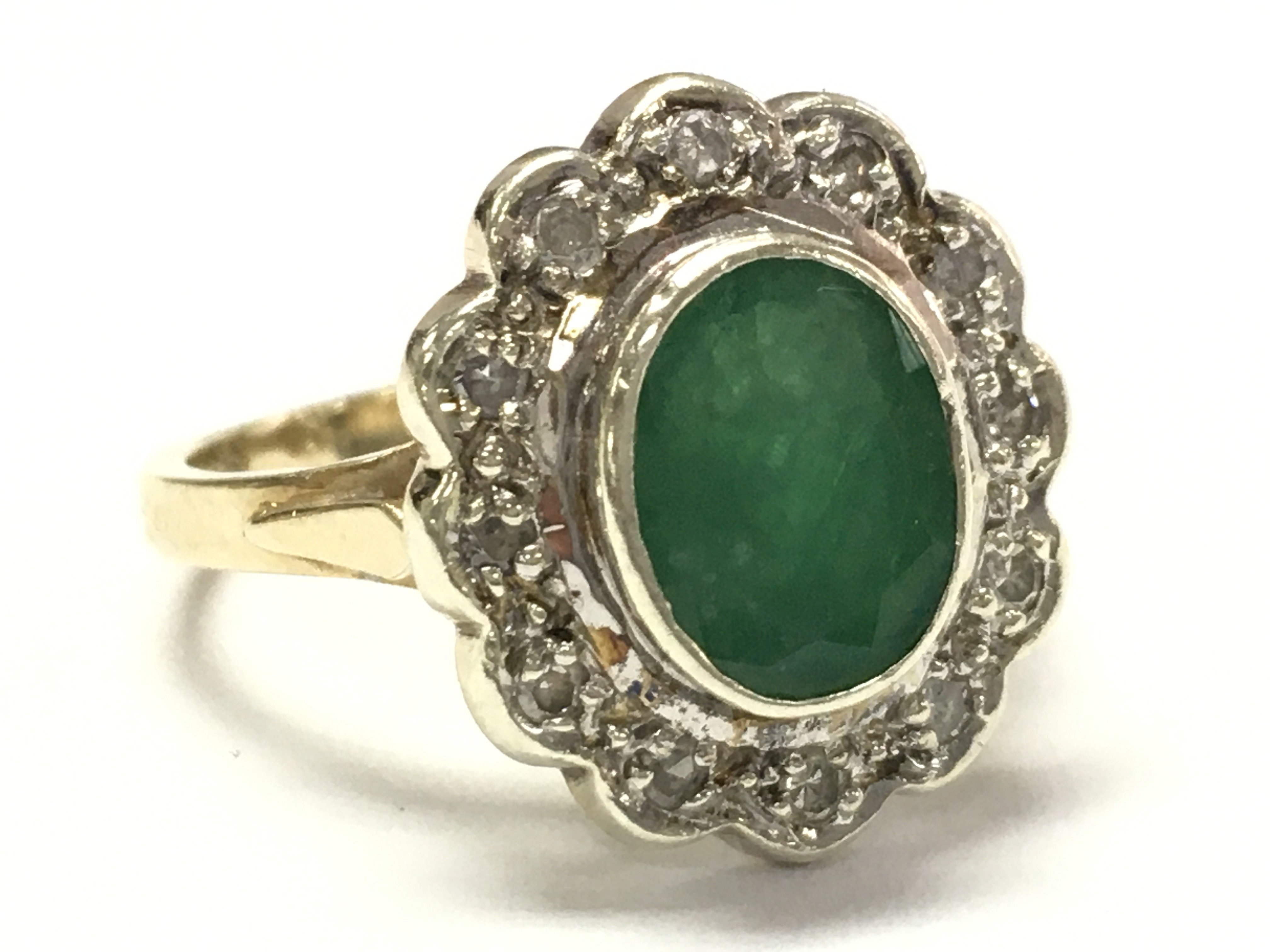 A 9ct gold emerald and diamond cluster ring size L/M. 4g total weight. Postage category A