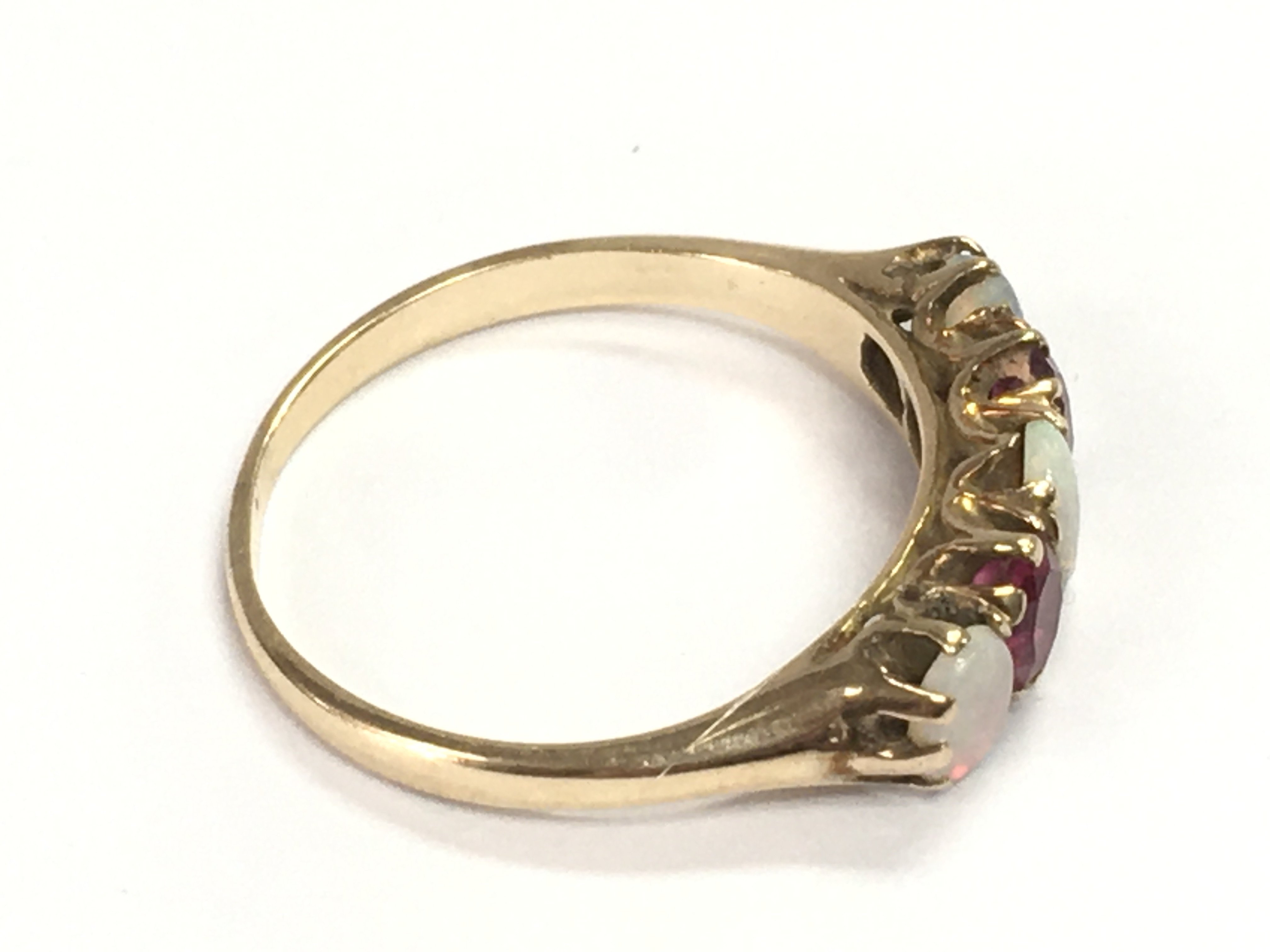 An unmarked ruby and opal ring size P 1/2 and 2.92g Postage A
