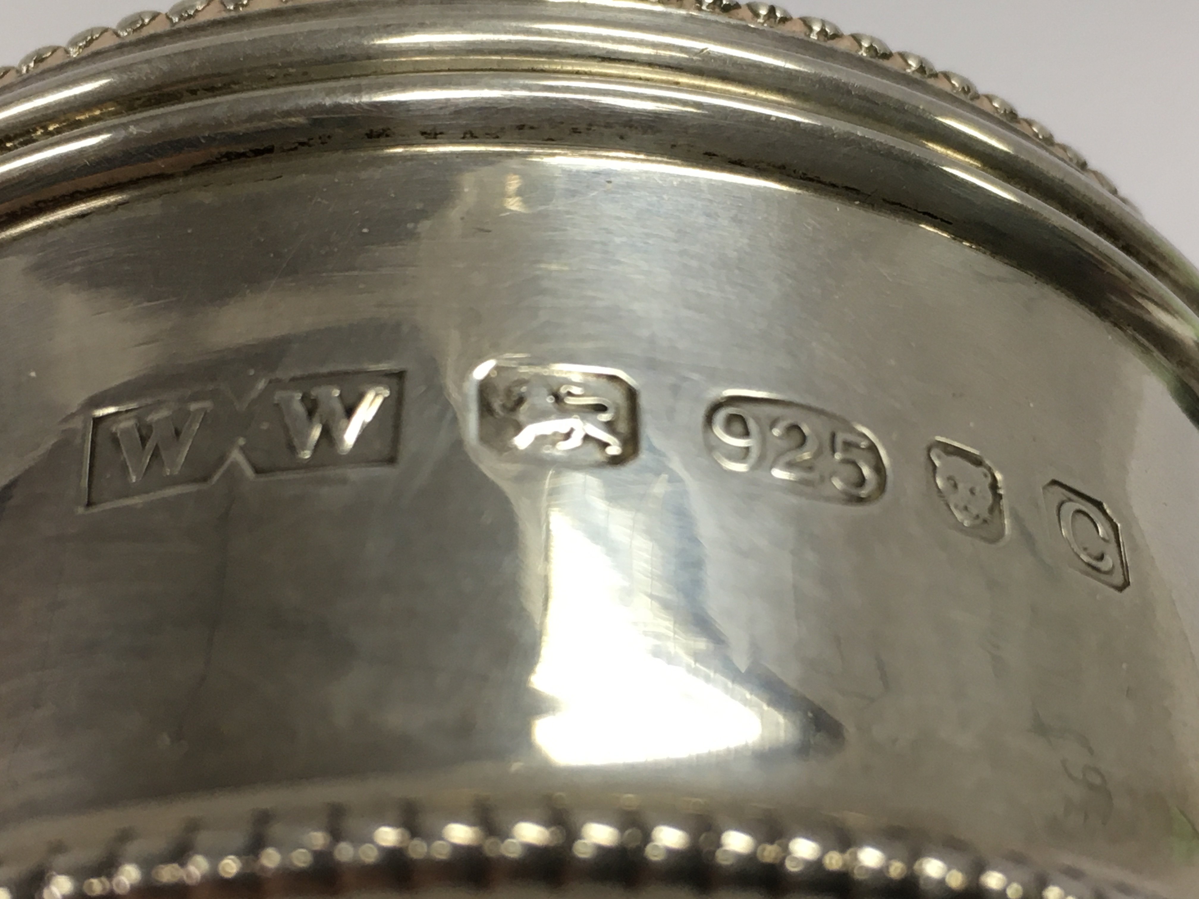 A circular silver hallmarked bead pill trinket box with an 1890s Mappin & Webb buckle . 107.8g Approx total. postage category A