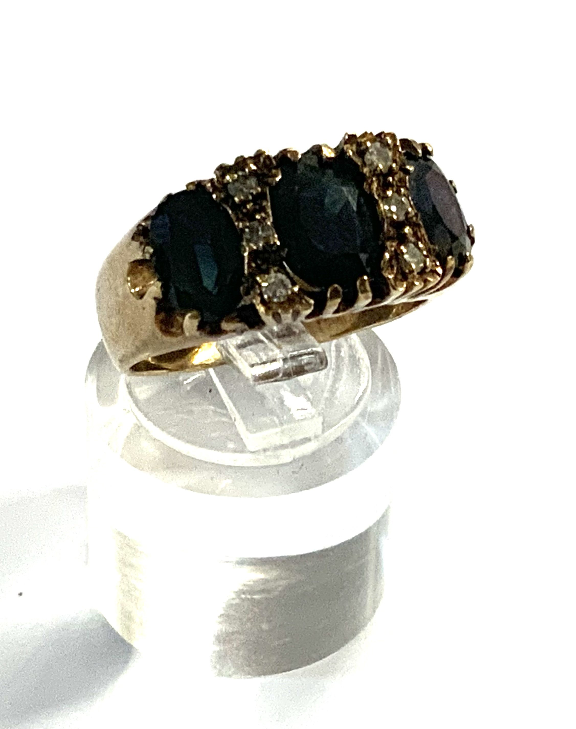 A 9ct gold sapphire and diamond cluster ring. (A)