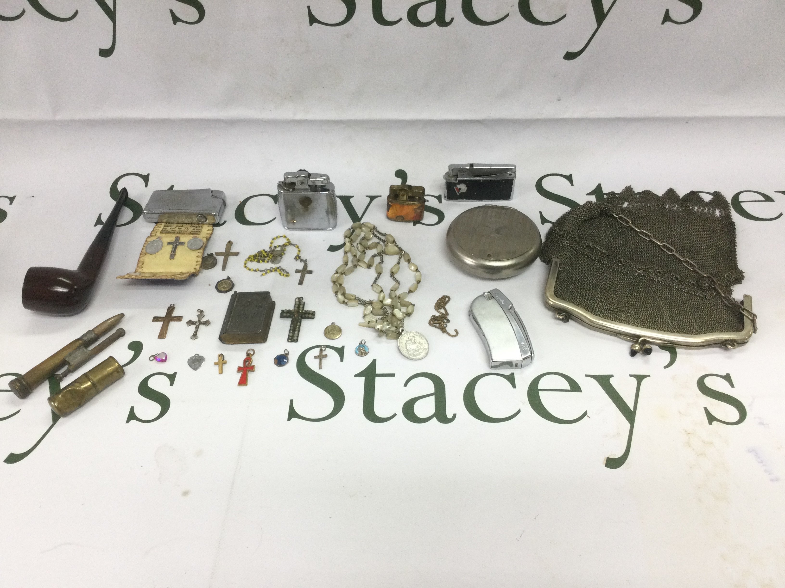 A small collection of costume jewellery including a 9ct gold crucifix, a mesh purse, lighters etc. Shipping category B.