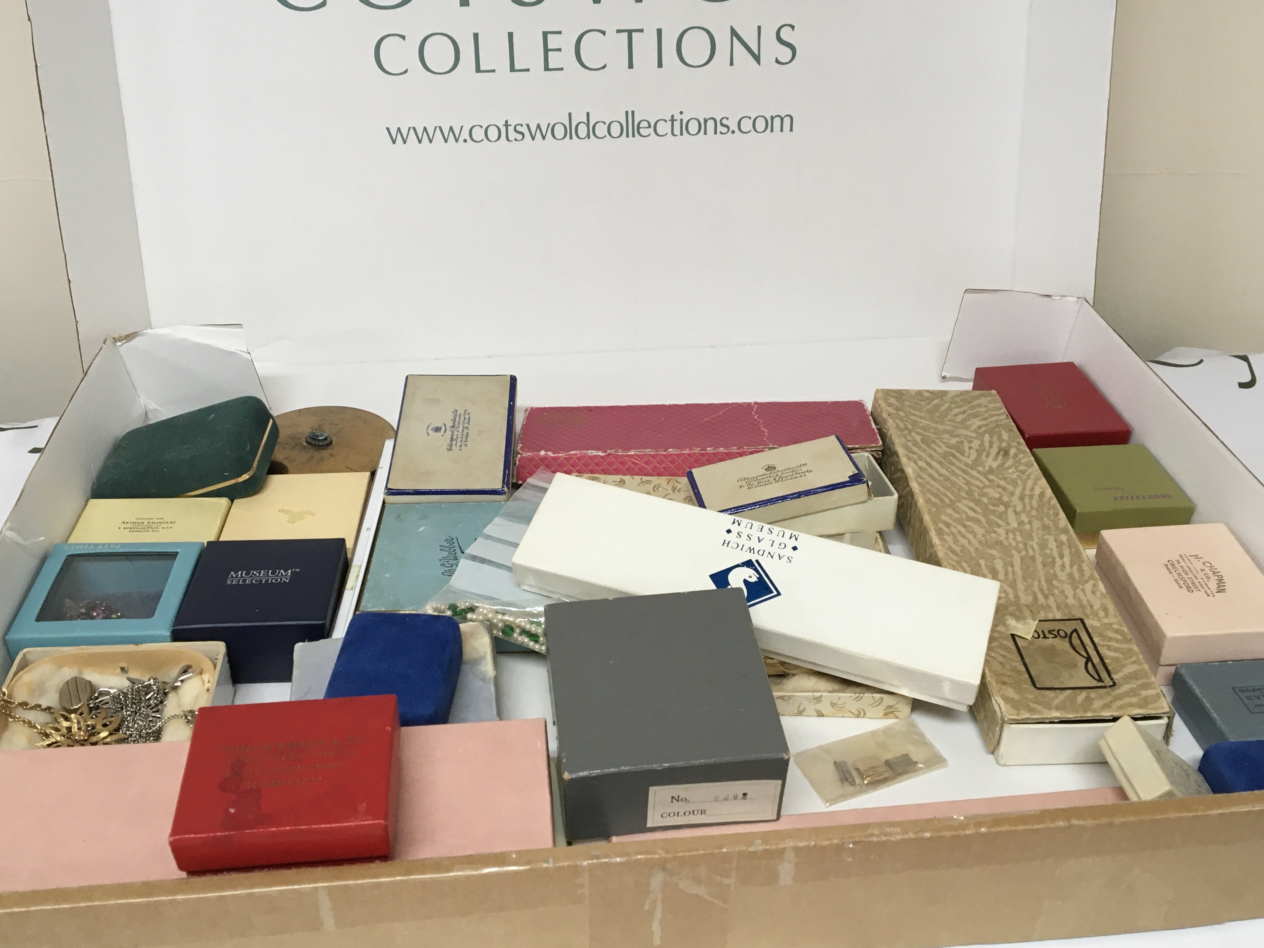 A box containing a quantity of costume jewellery watches and other oddments most in presentation boxes.