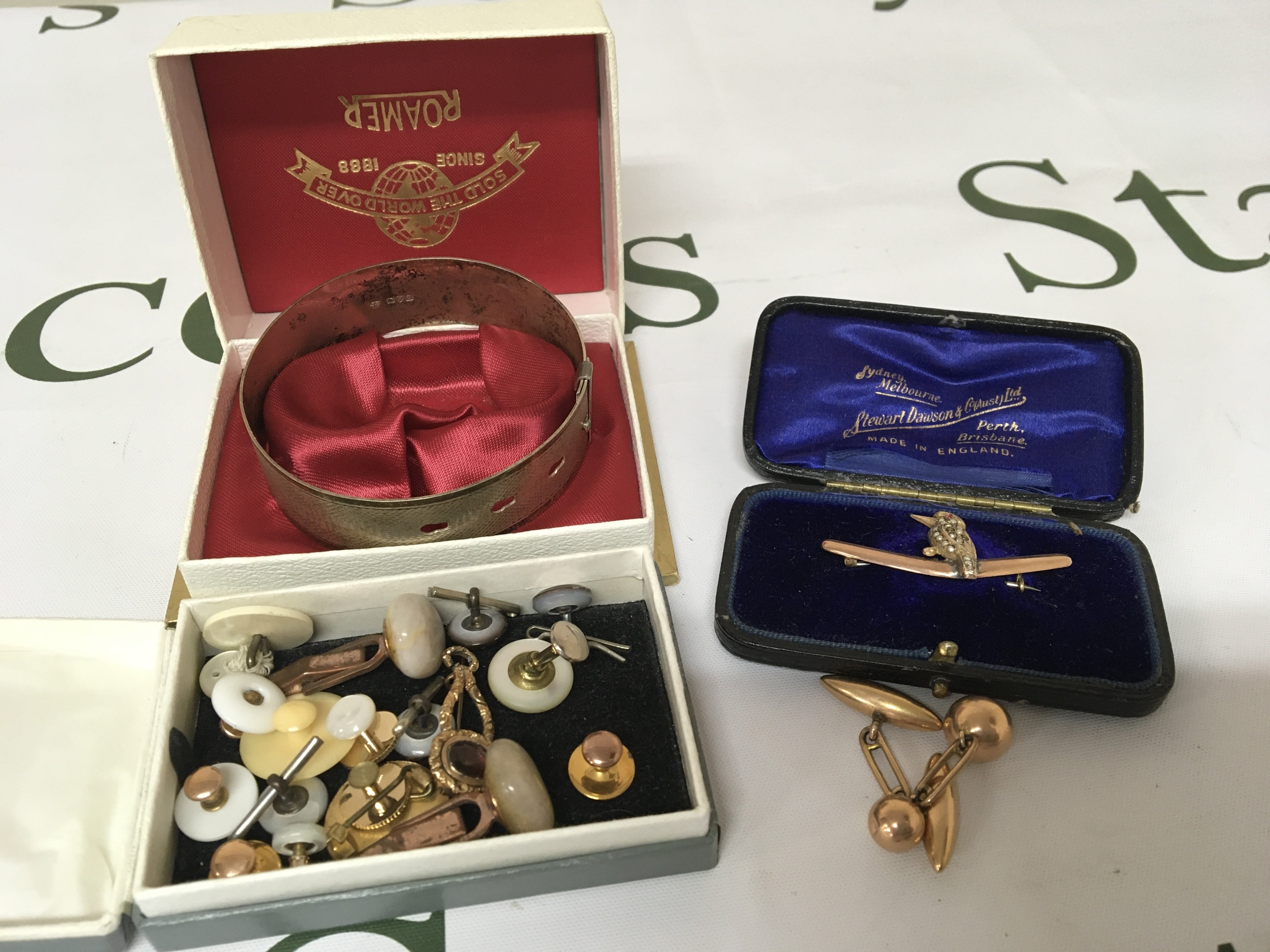 Apair of unmarked cufflinks a gold brooch with a bird set with seed pearl a silver bangle and a quantity of gents cufflinks in a box