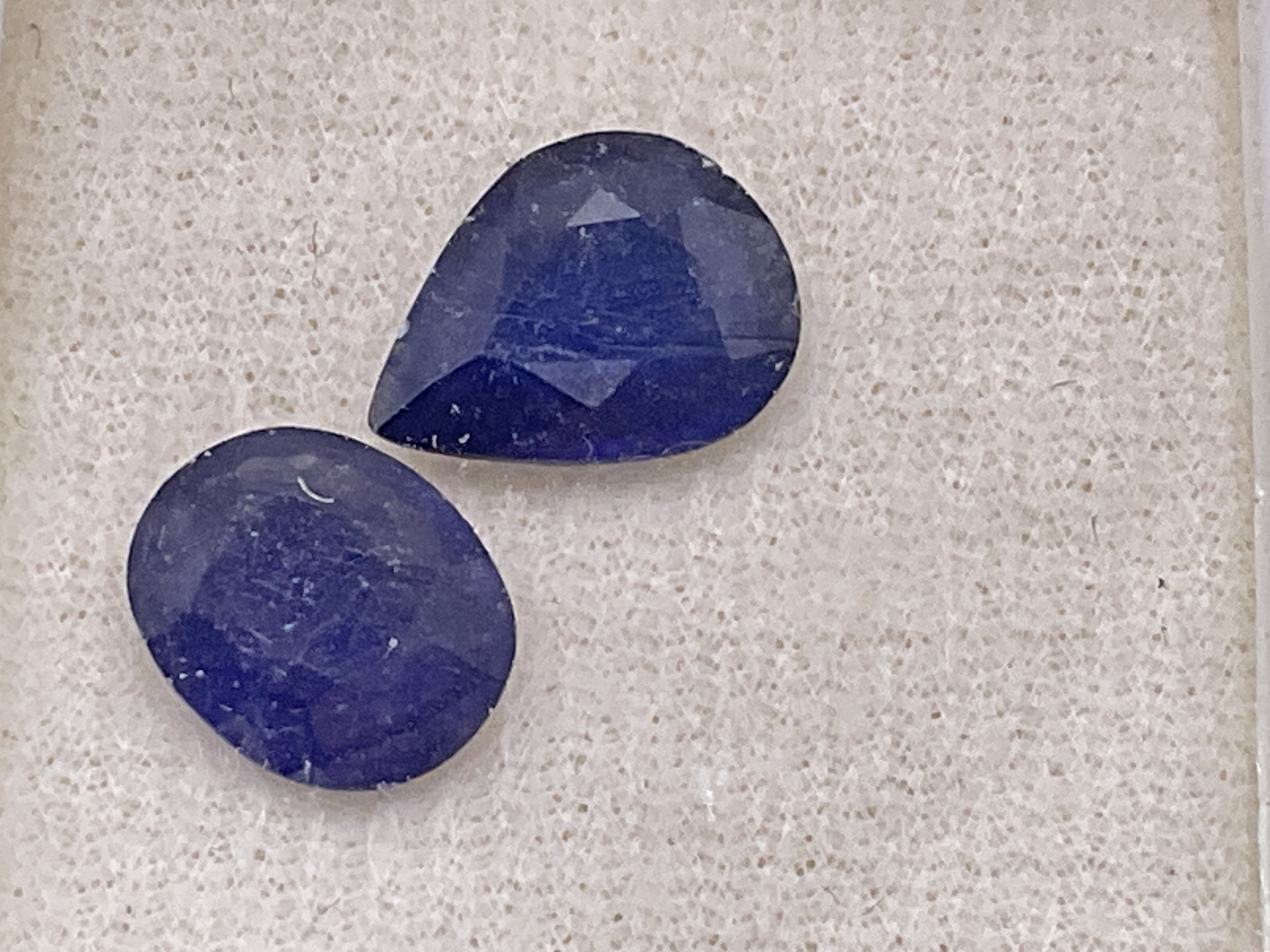 2 loose boxed sapphires (glass filled). Pear 2.92ct. Oval 2.74ct. Postage category A.