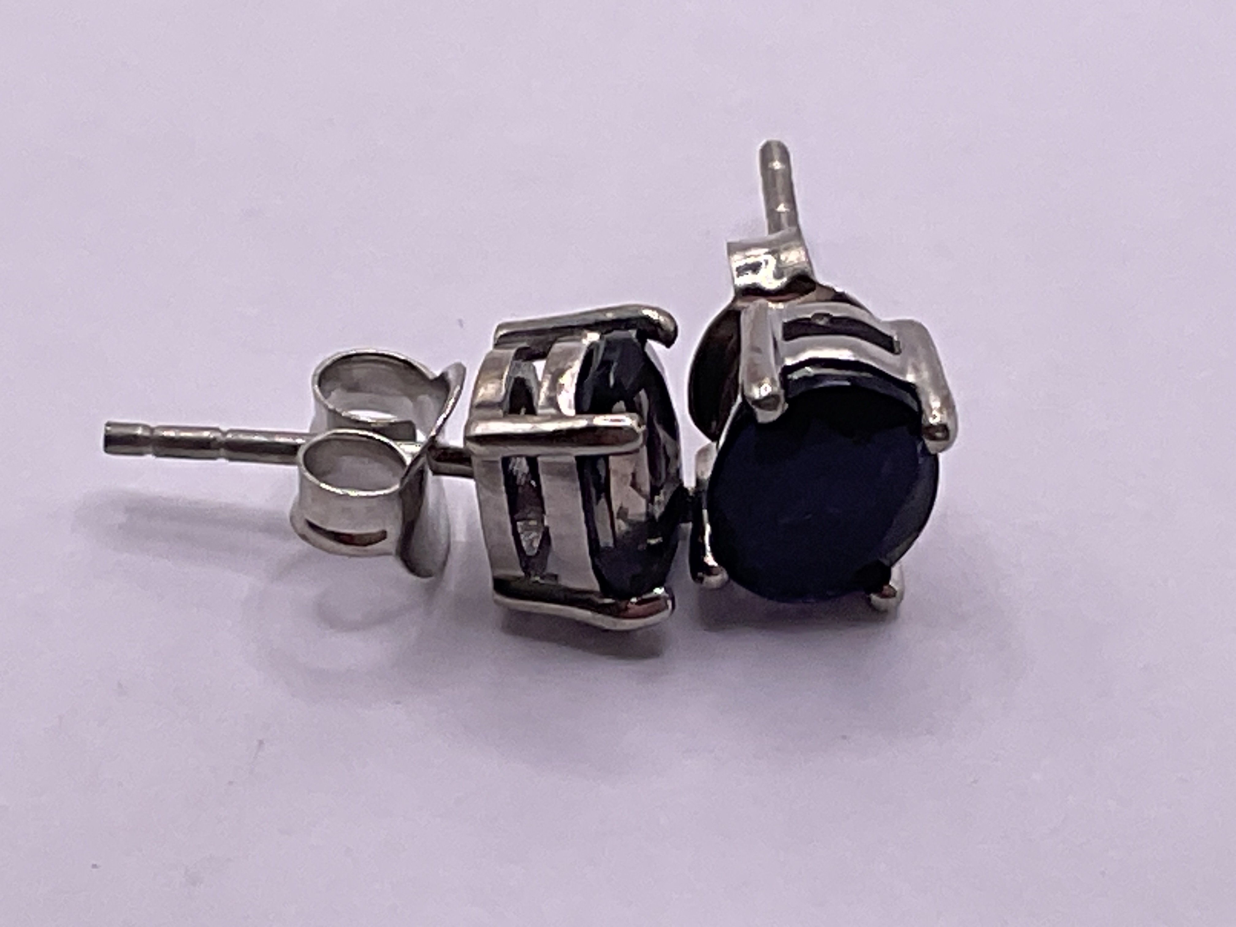Pair of iolite studs in silver. Postage category A.