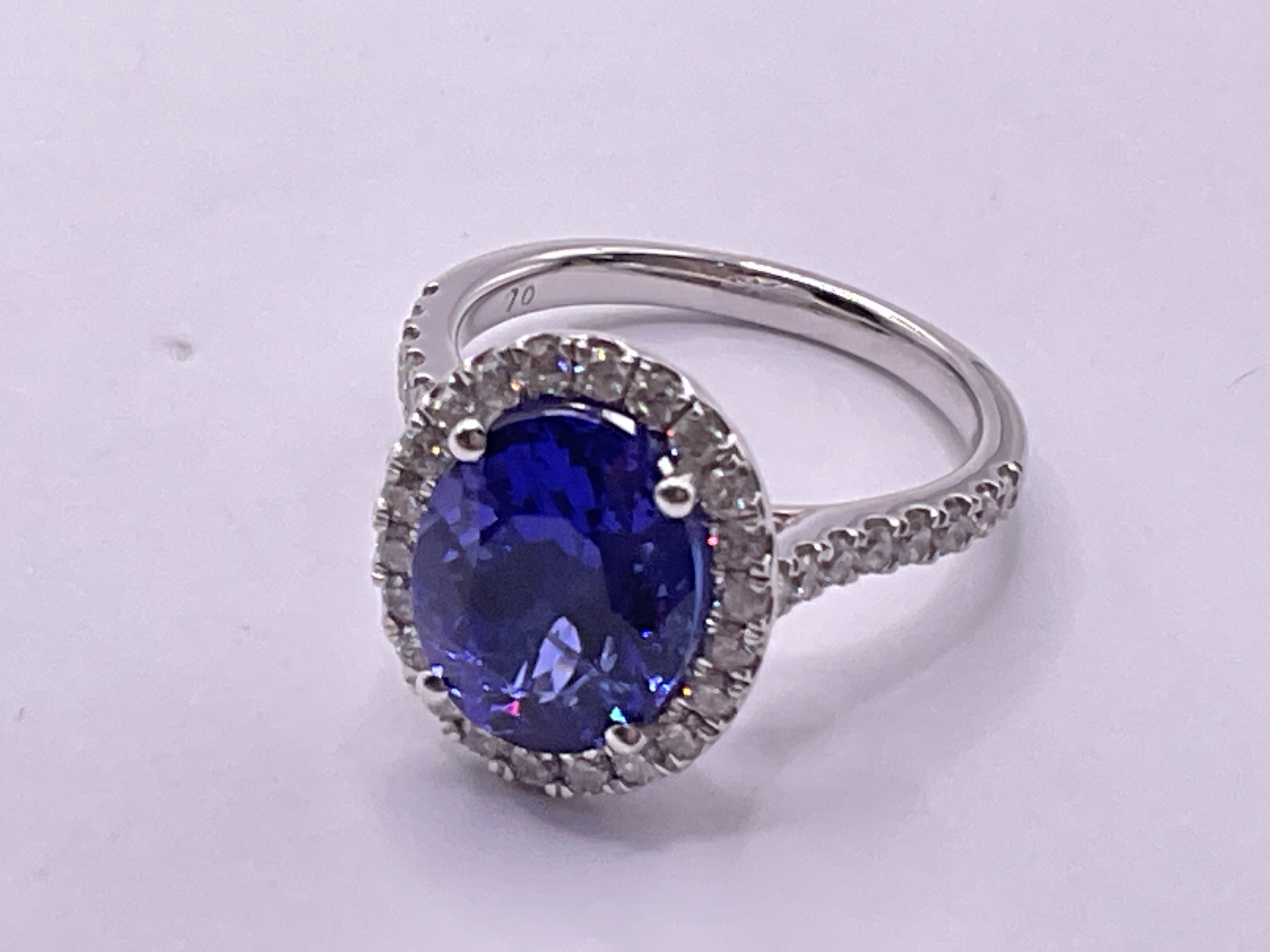 Certified platinum ring set with an oval tanzanite surrounded by RBC diamonds with RBC diamond set shoulders. Tanzanite 4.51ct. Diamonds 0.76ct / G-H cert no. WGI9634157939. Ring size approx O. Postage category A.