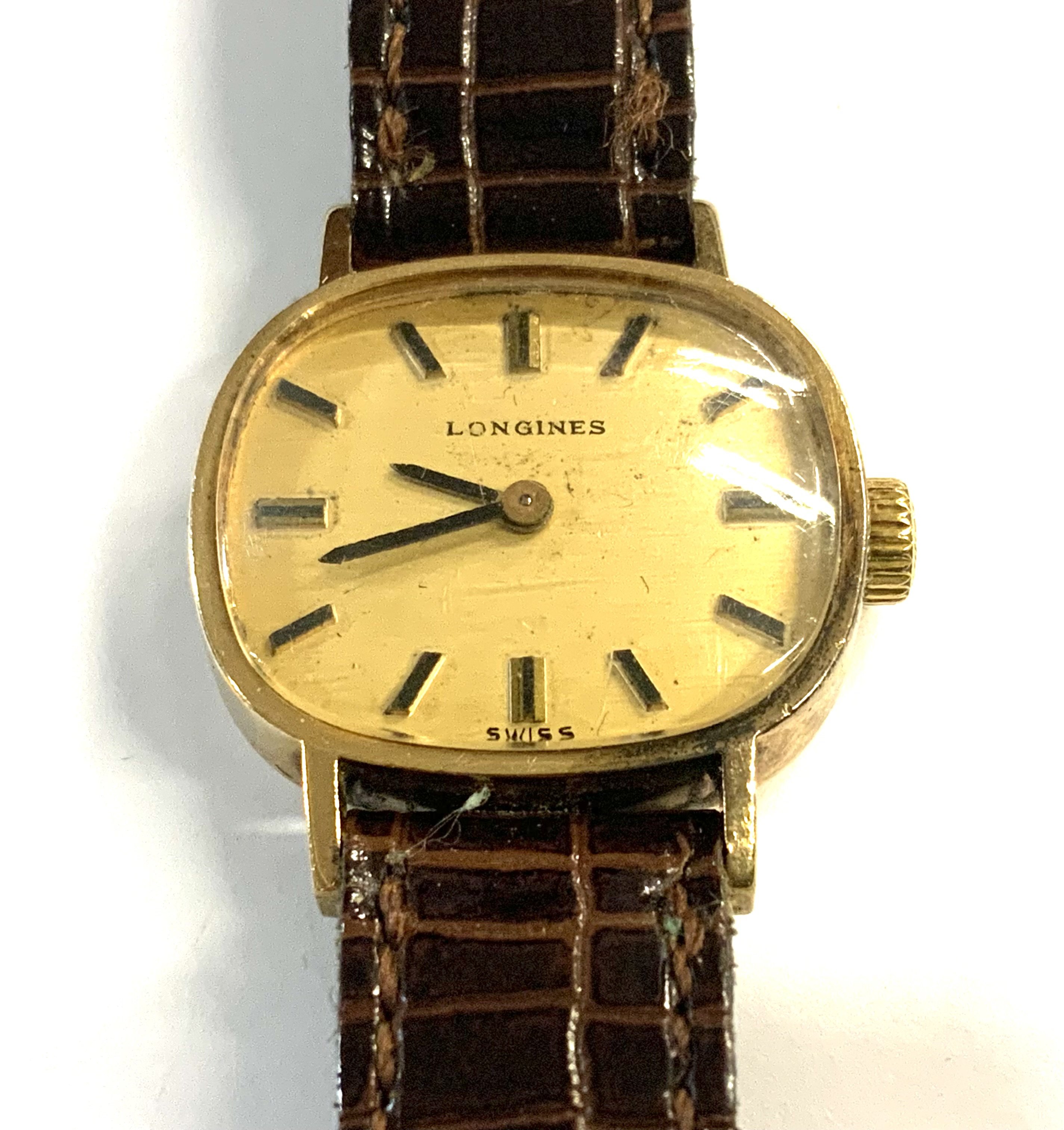 A ladies 9ct gold cased longines wristwatch with crocodile skiing strap.