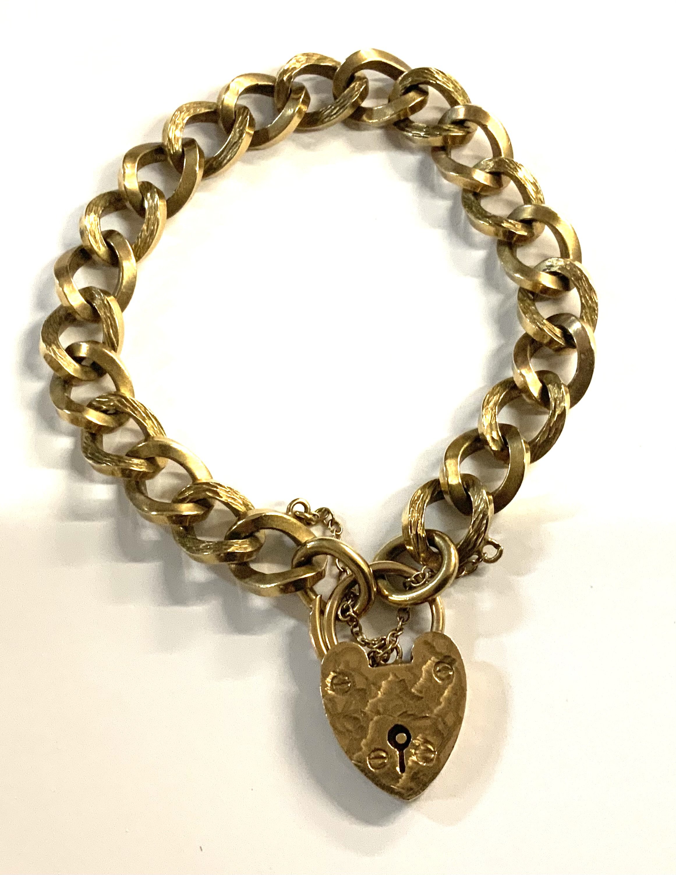 A 9ct gold heart locket and chain bracelet. 34.49 (A)