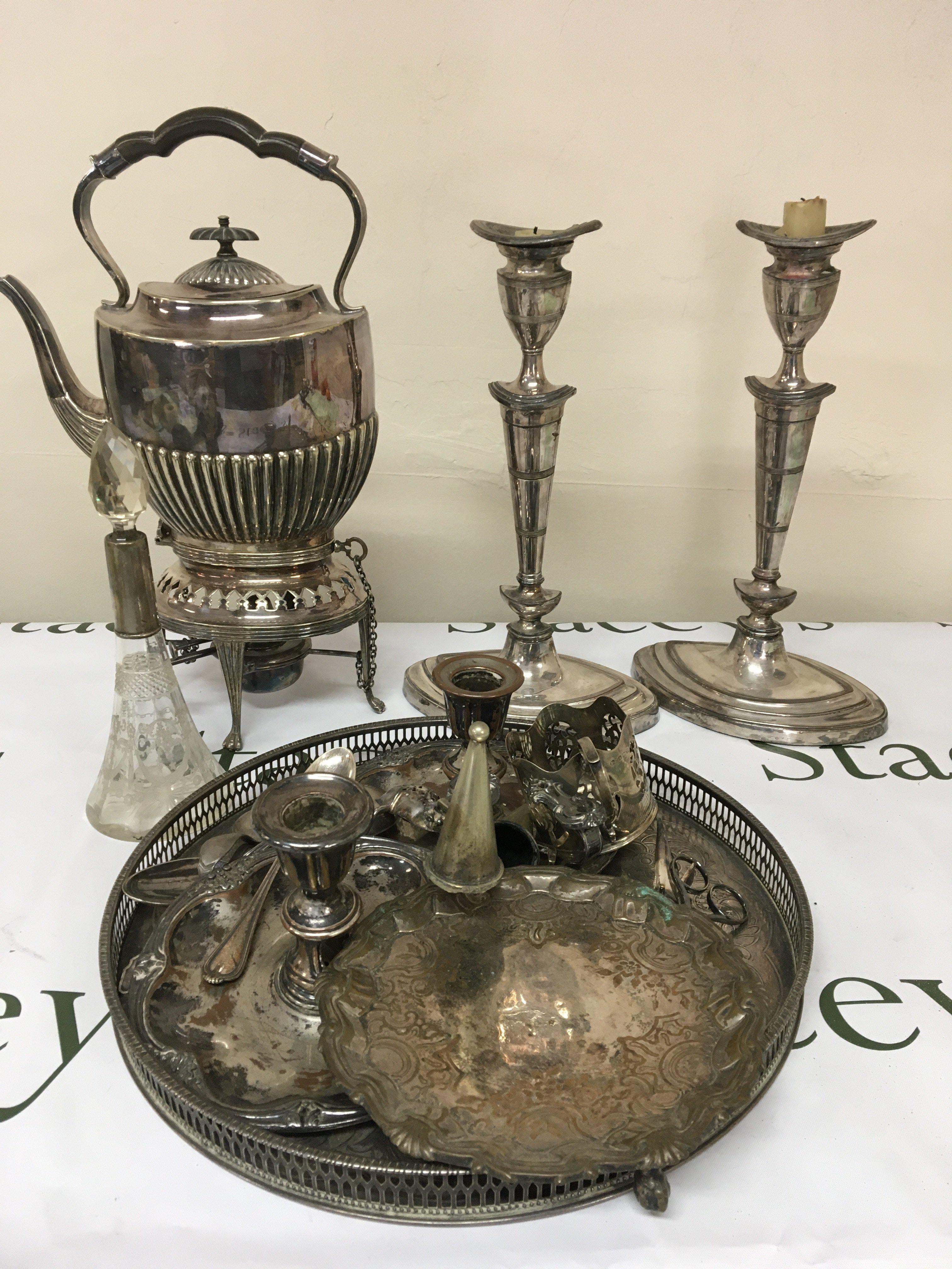 A silver plated spirit kettle a pair of Neo-classical silver plated candle sticks other plated items and some silver.