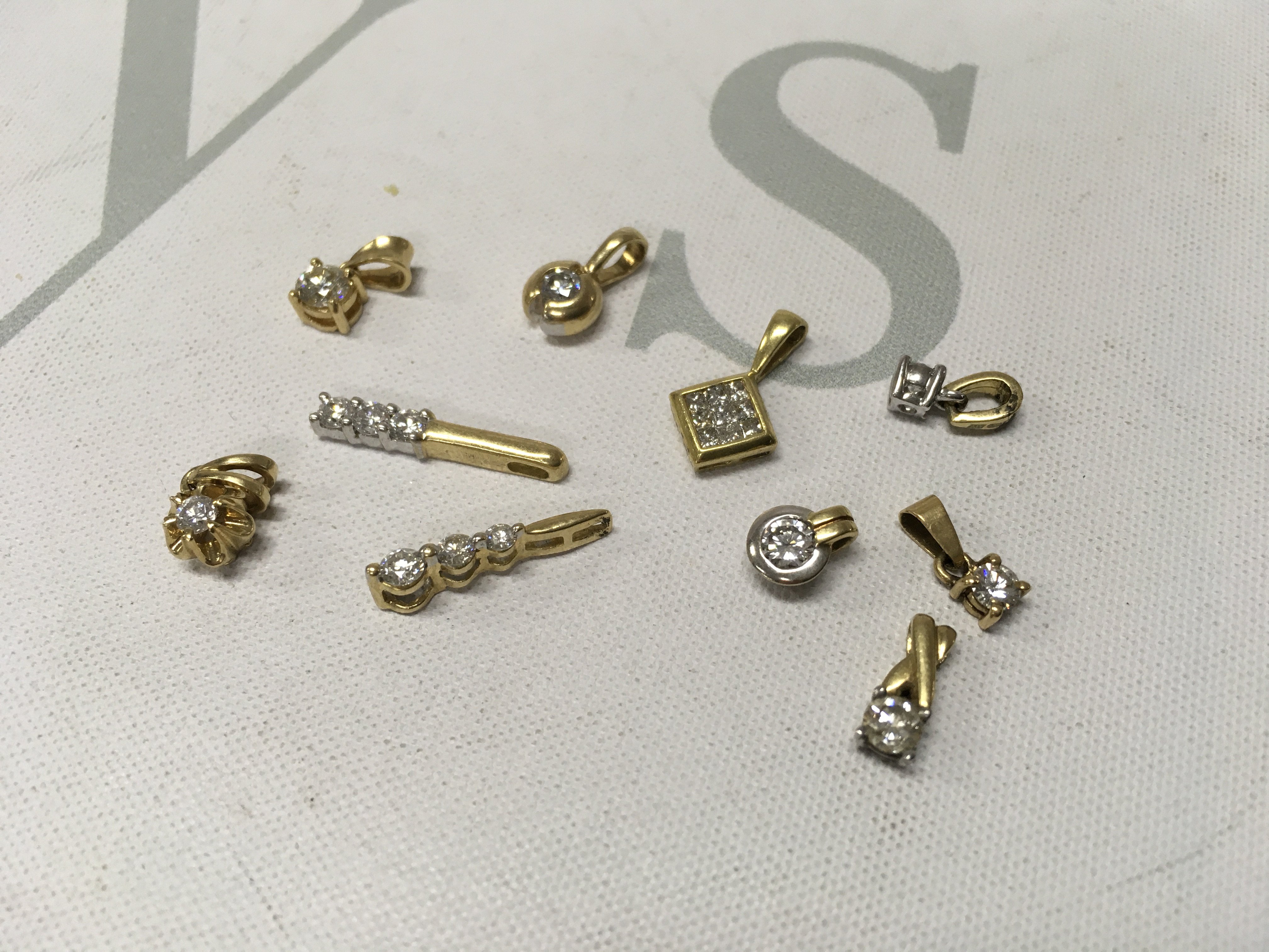 A small assortment of stone set 18ct gold pendants. Approx weight 8.8 grams.