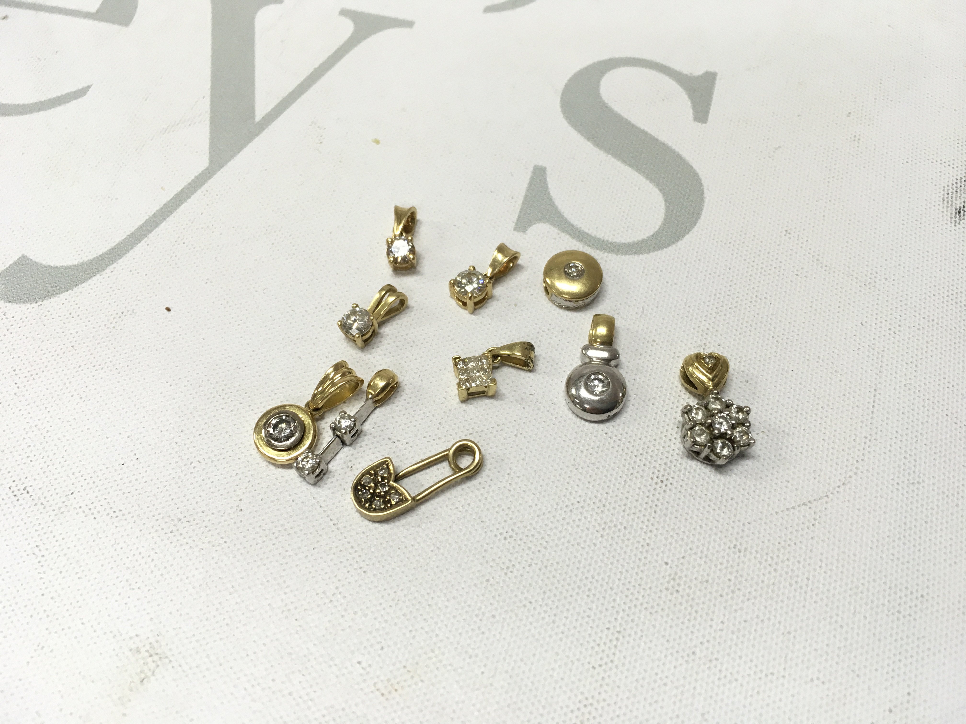 An assortment of 18ct gold stone set pendants. Approx weight 10.9 grams.