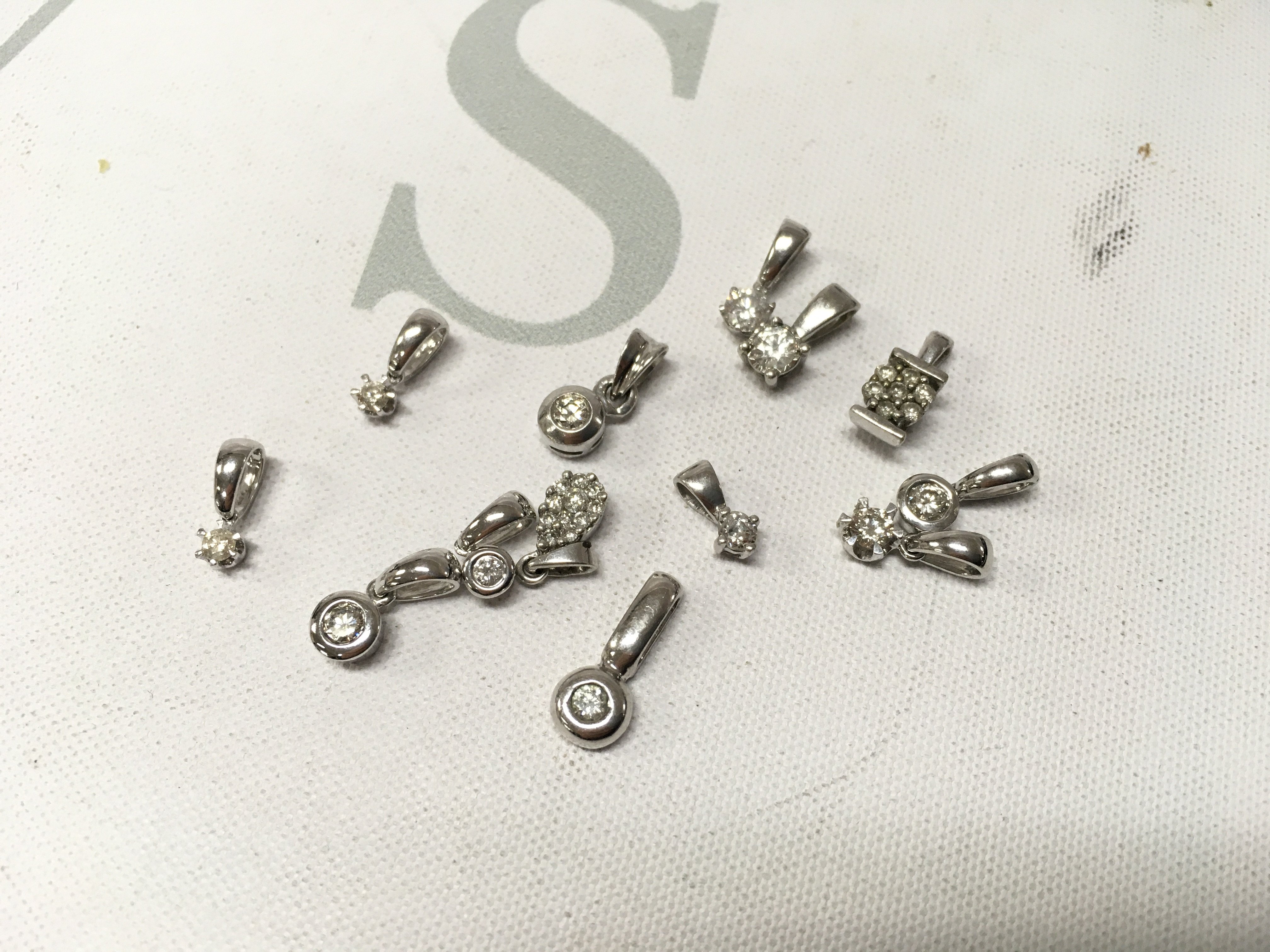 An assortment of 9ct hire gold stone set pendants. Approx weight 6.9grams.