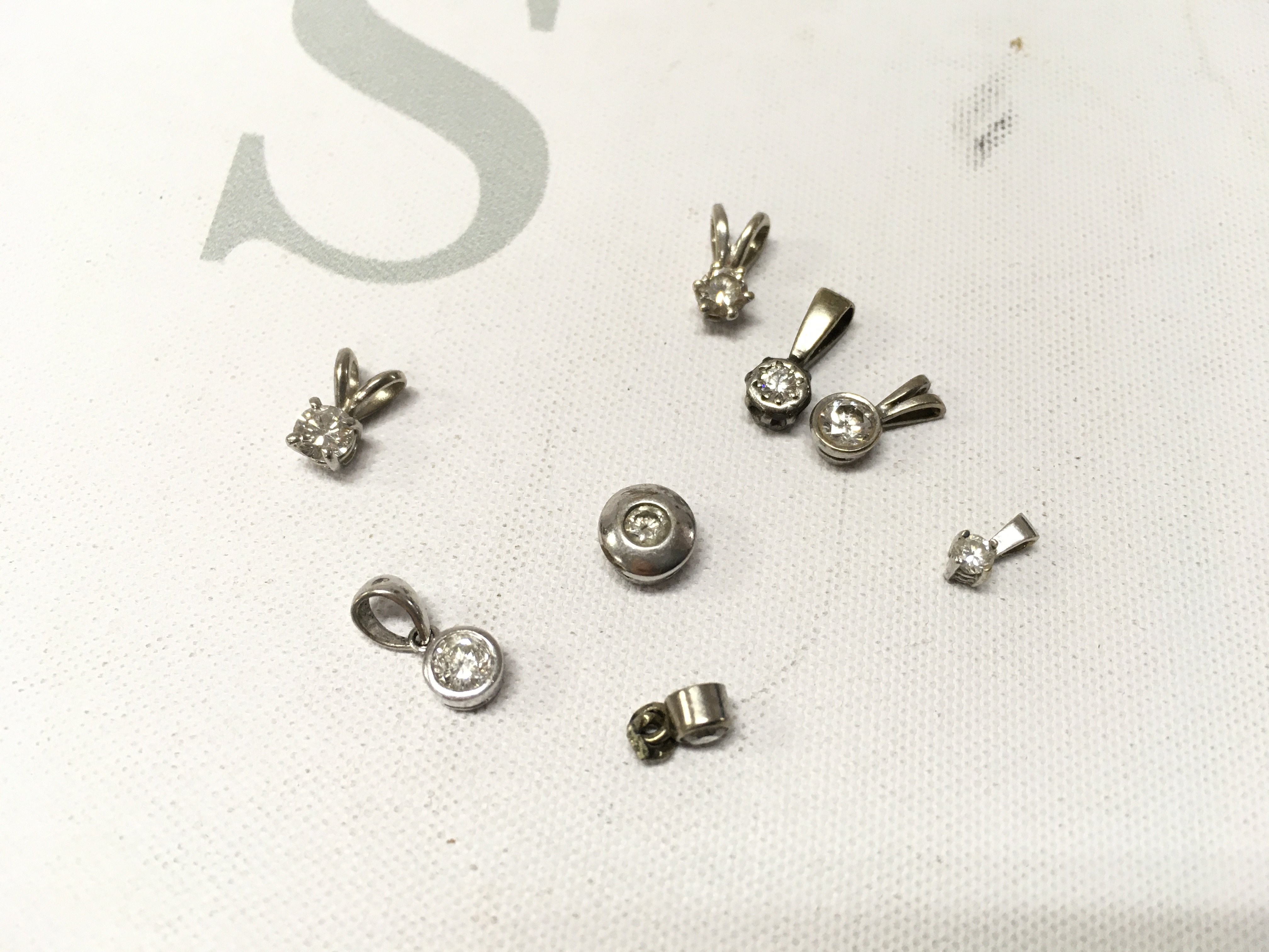 An assortment of unmarked white metal stone set pendants. Approx weight 3.9grams.