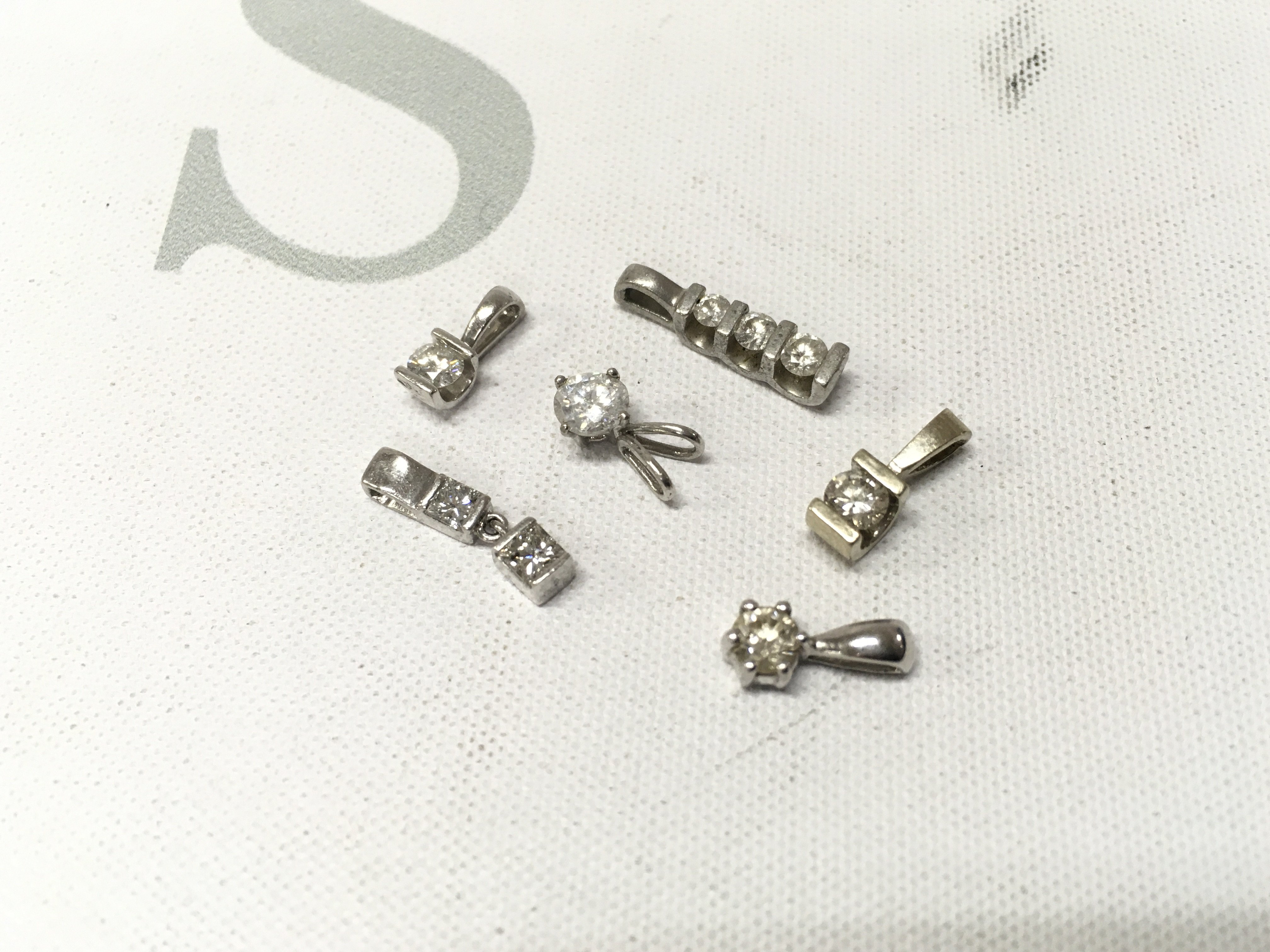 A mixed assortment of 14ct white gold and platinum diamond set pendants. Approx weight 6grams.