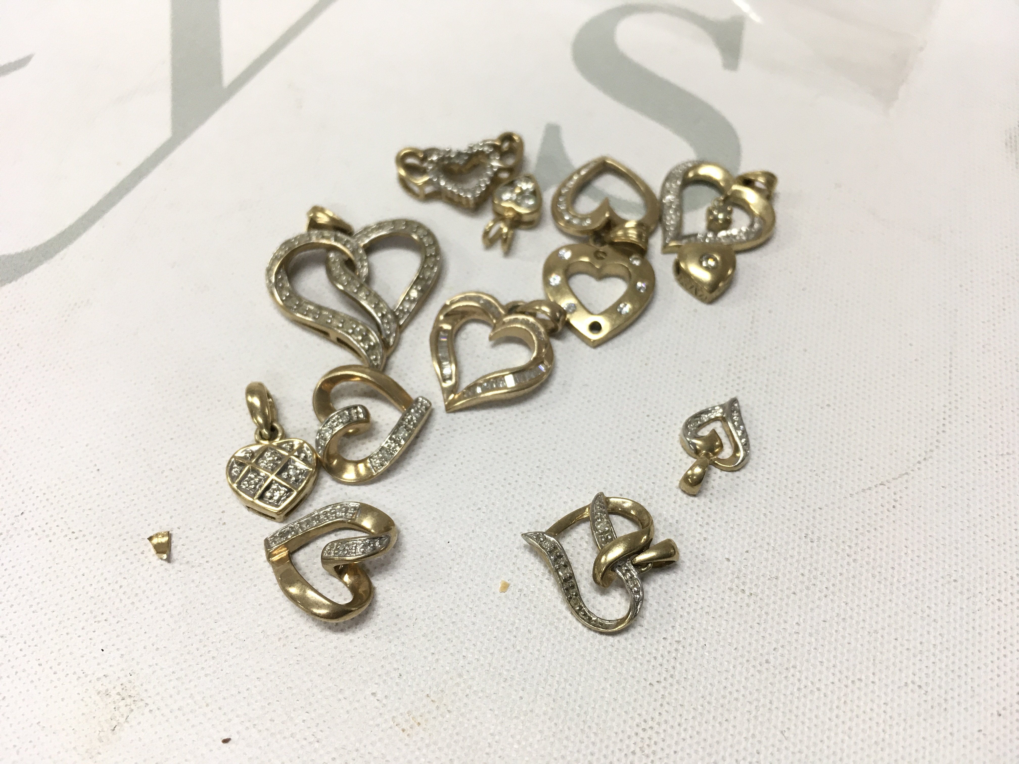 A small collection of 9ct gold diamond set heart pendants. Approx weight 12.2 grams.