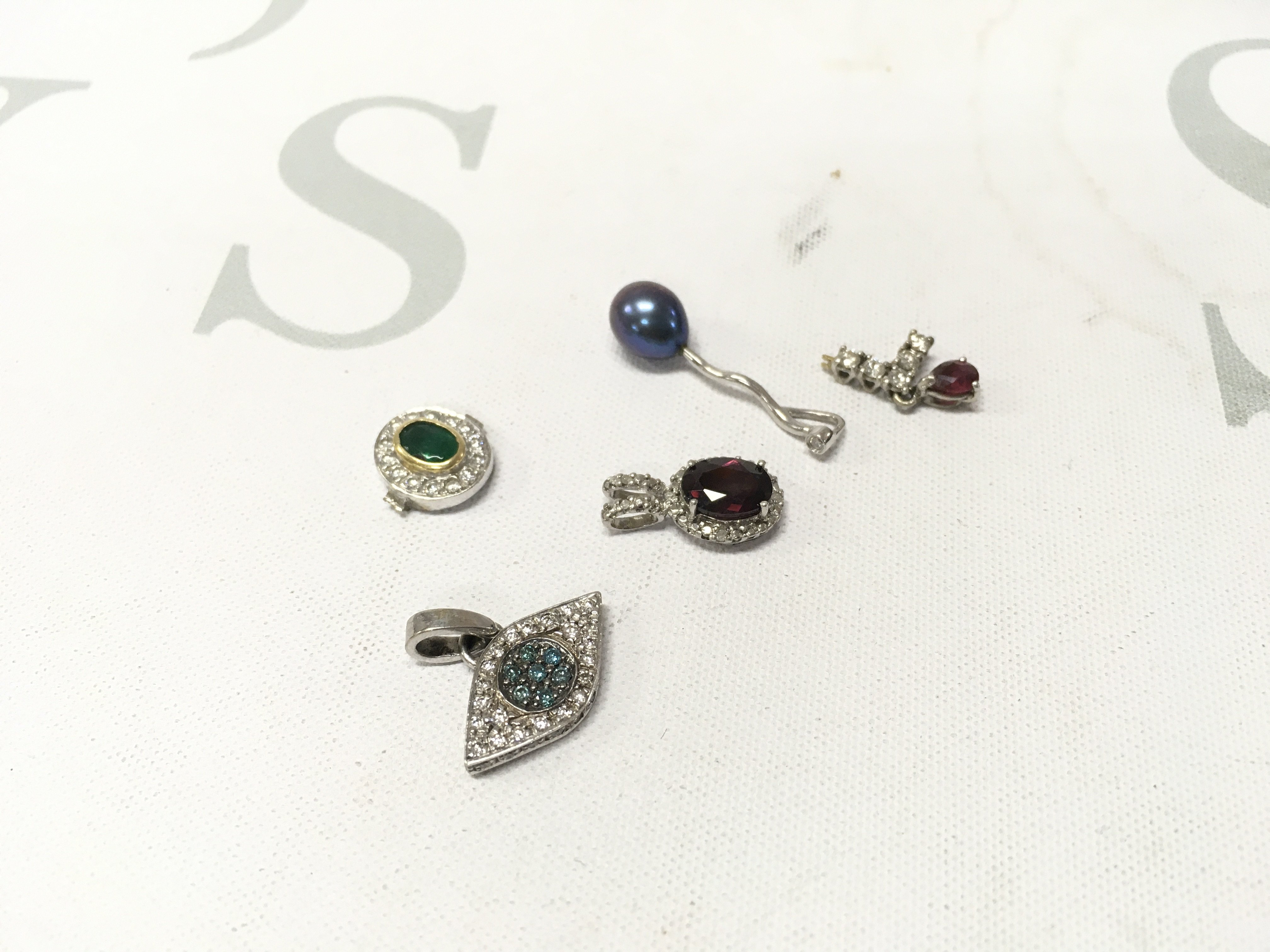 A mixed assortment of unmarked white metal stone set pendants. Approx weight 7.0 grams.