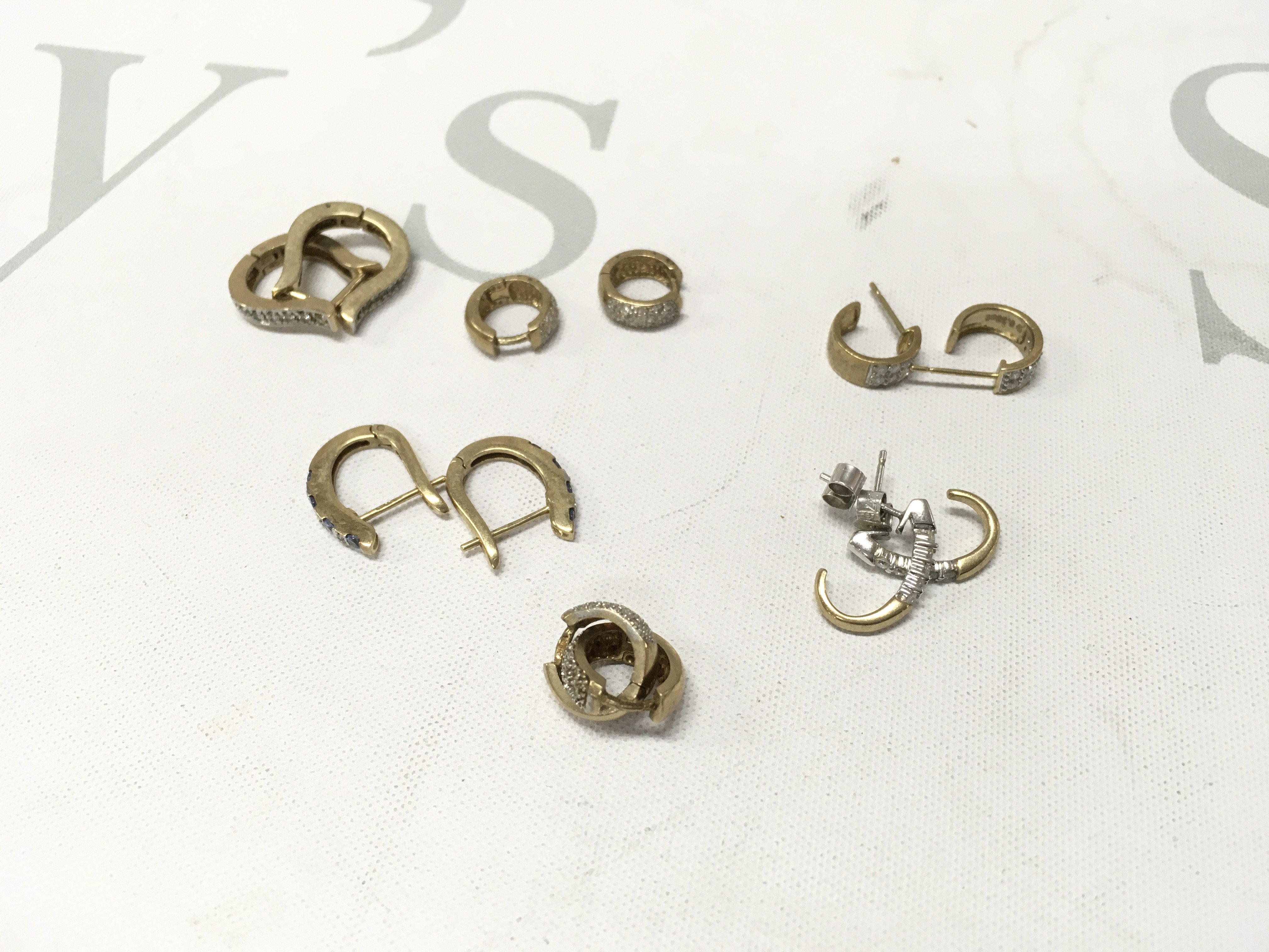 Six pairs of 9ct gold stone set hoop style earrings. Approx weight 14 grams.
