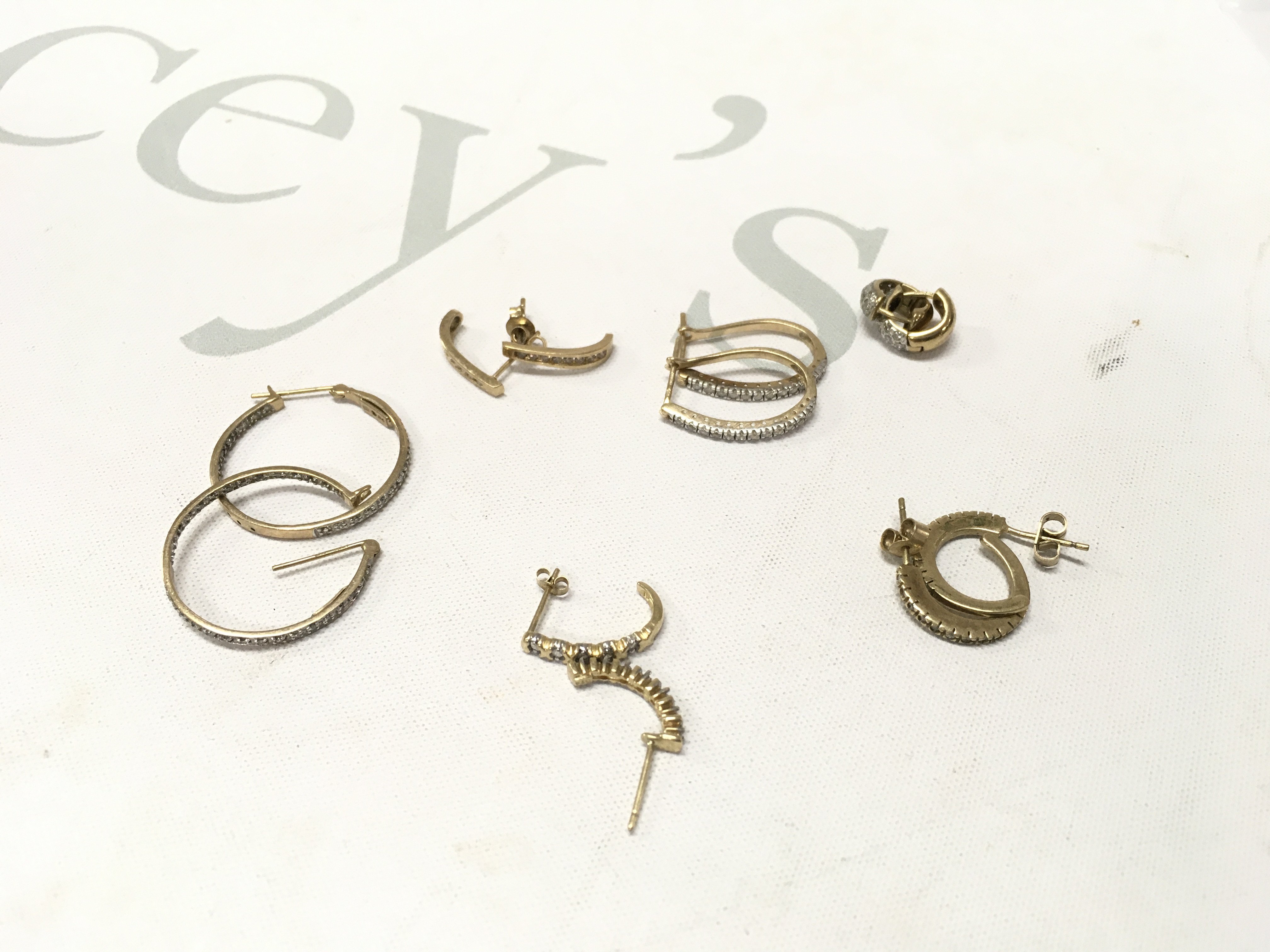 Six pairs of 9ct gold stone set hoop style earrings. Approx weight 13 grams.