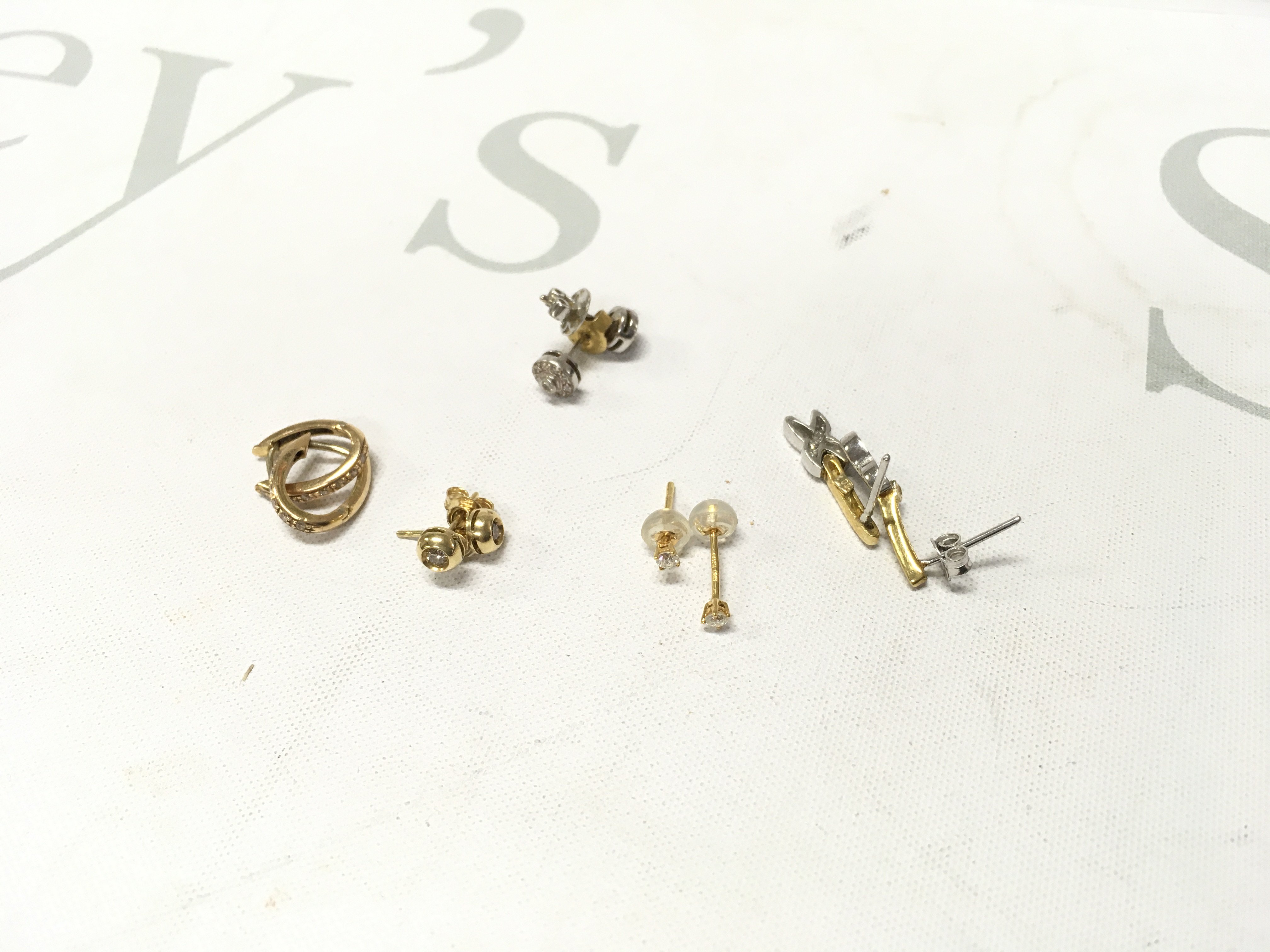 Five pairs of 18ct gold stone set studs. Approx weight 8.8 grams.