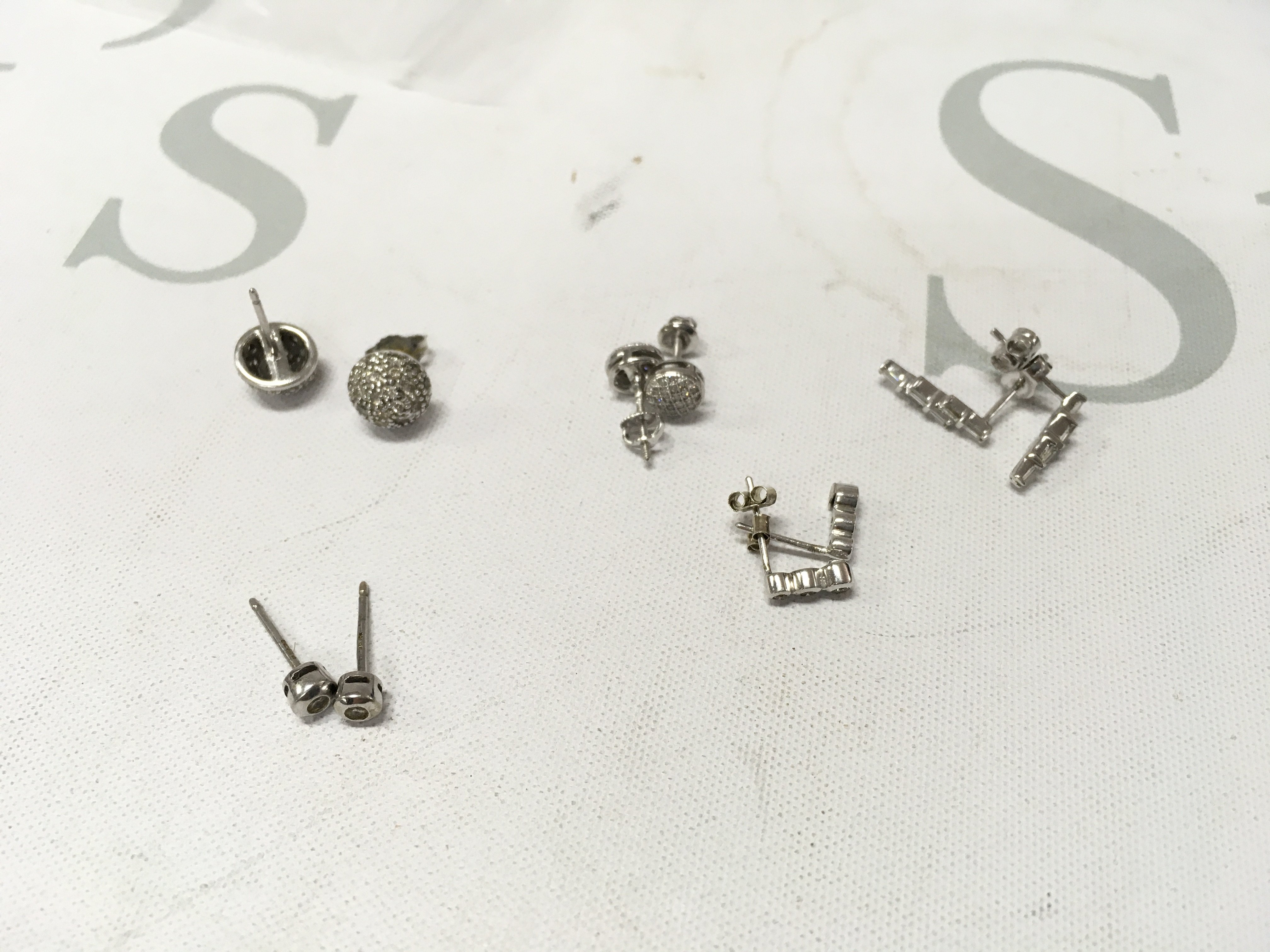 Five pairs of stone set 9ct white gold studs. Approx weight 6.1grams.