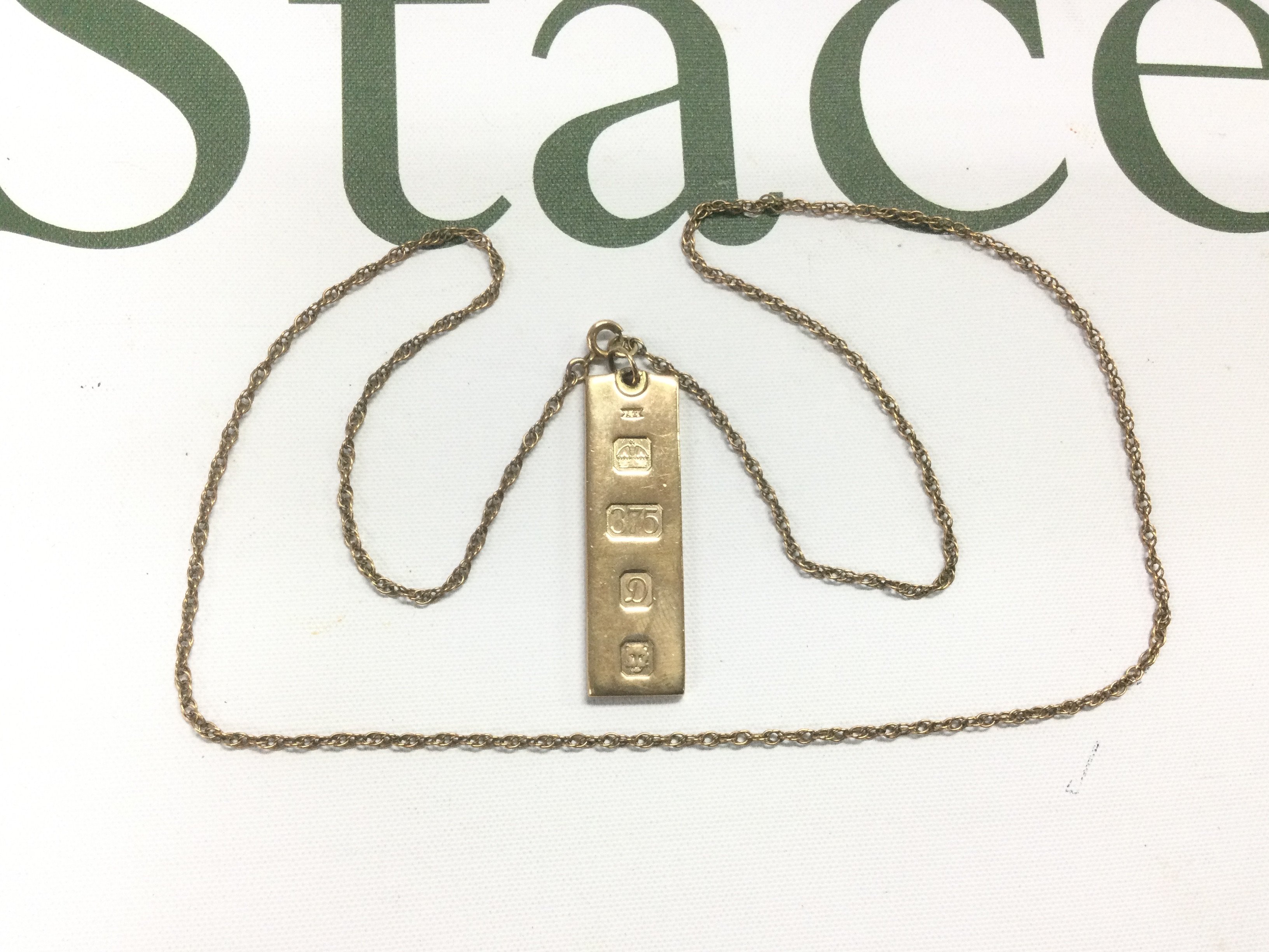 A 9ct gold ingot and chain, approx 18.2g. Shipping category A.